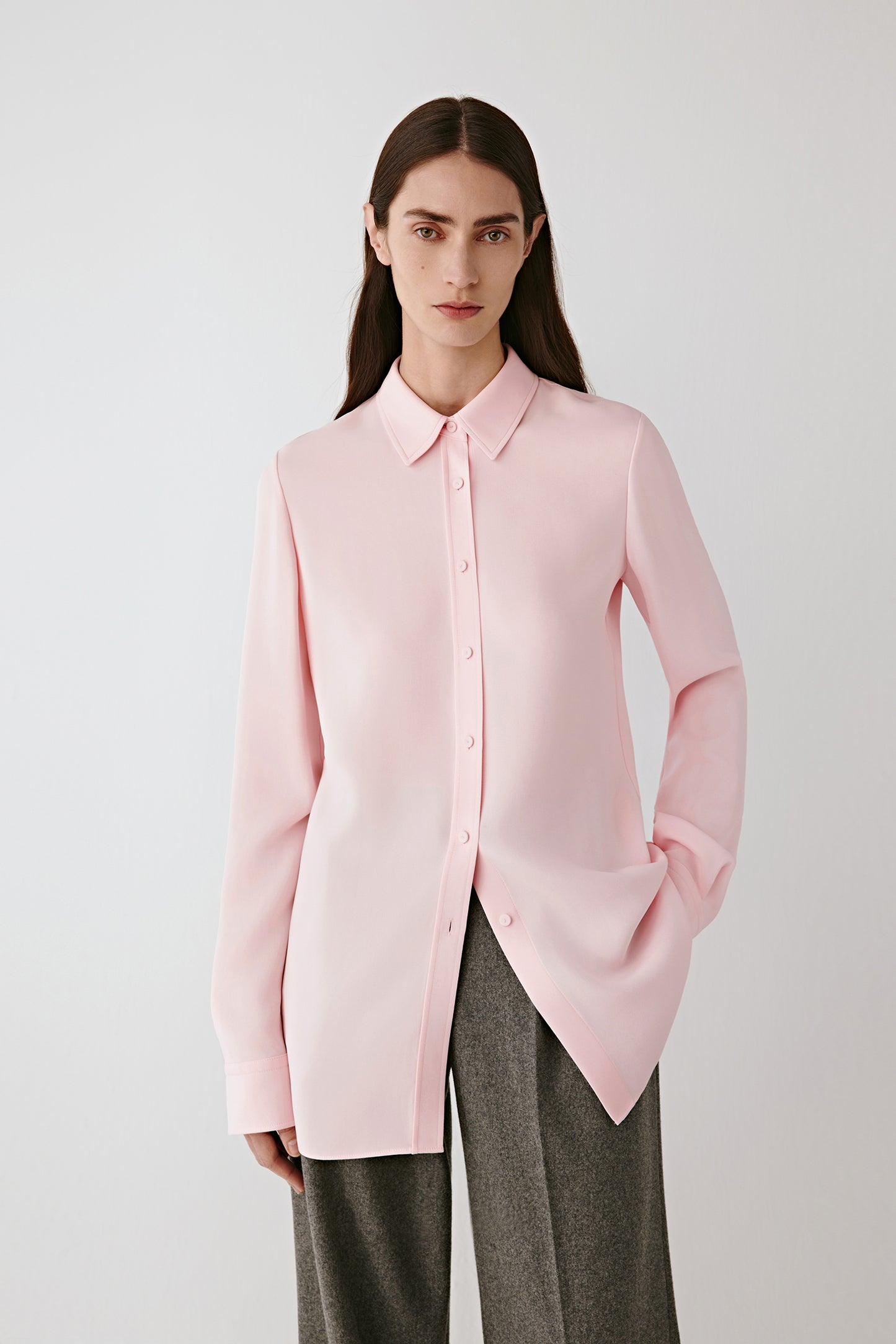 Three-quarter front view highlighting the clean lines of the shirt and the way the silk fabric falls smoothly over the shoulders and torso.