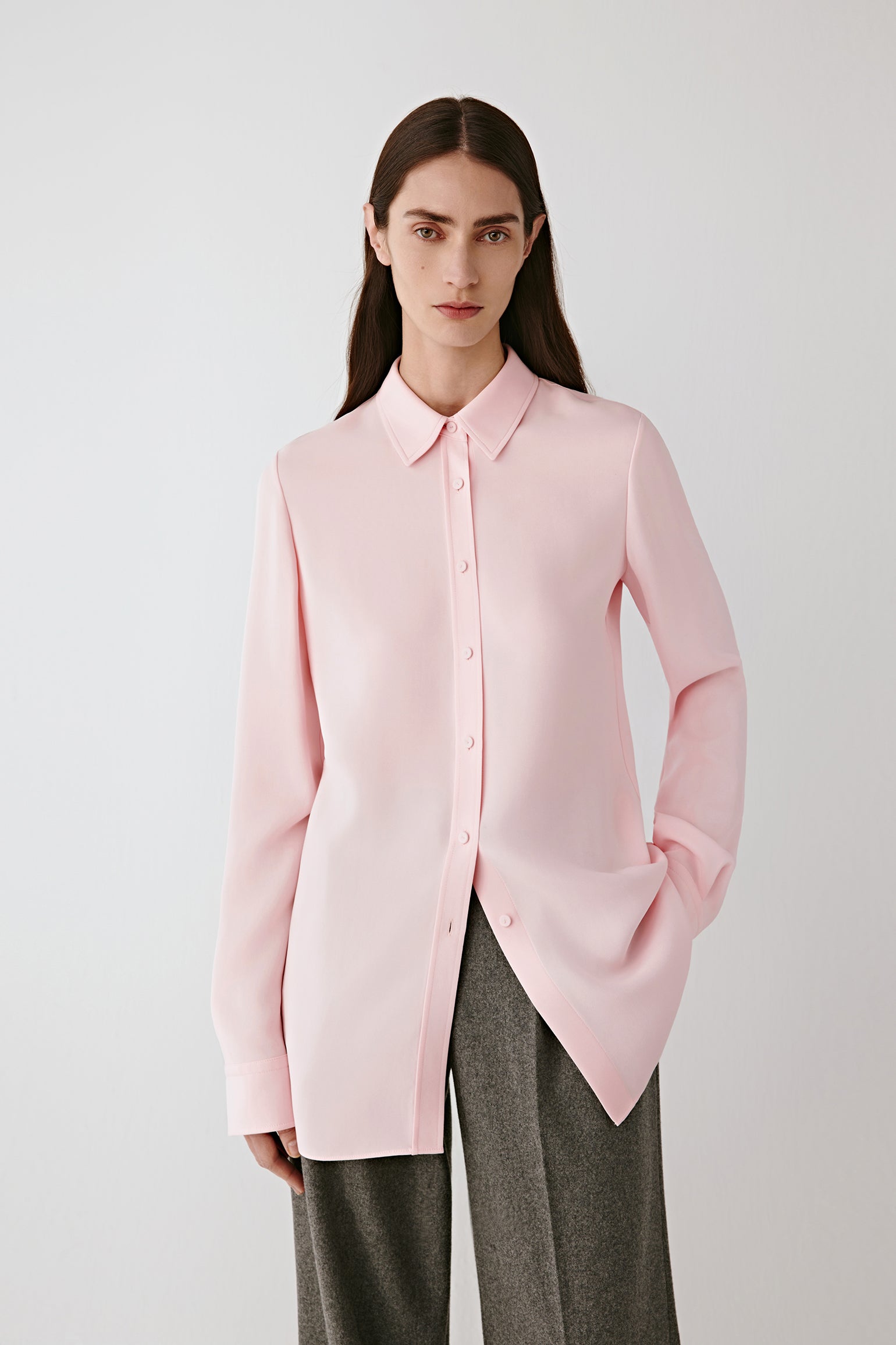 Three-quarter front view highlighting the clean lines of the shirt and the way the silk fabric falls smoothly over the shoulders and torso.