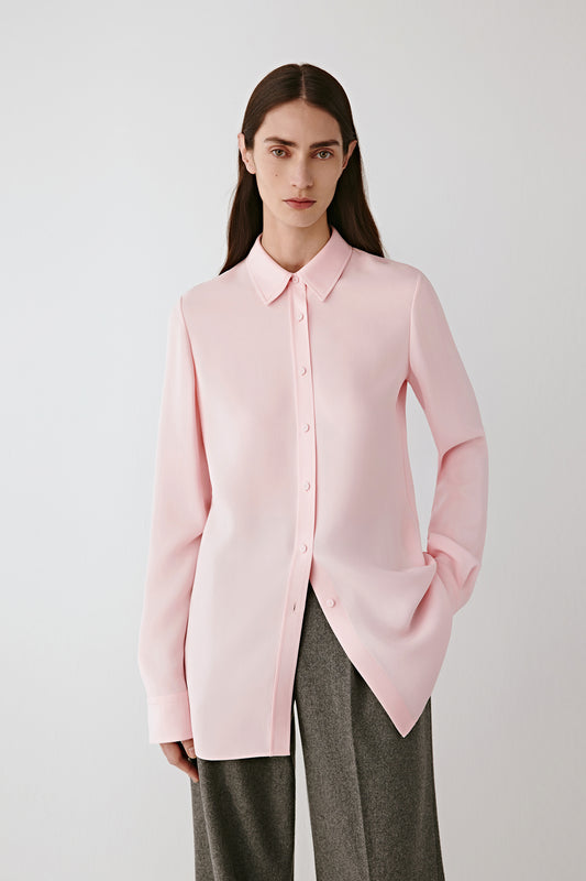 Three-quarter front view highlighting the clean lines of the shirt and the way the silk fabric falls smoothly over the shoulders and torso.