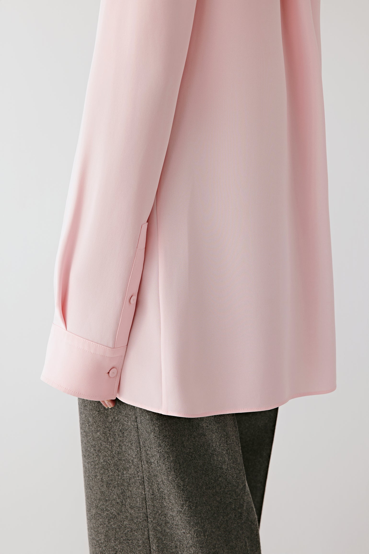 Close-up of the front showing the refined button placket and delicate texture of the heavy silk.