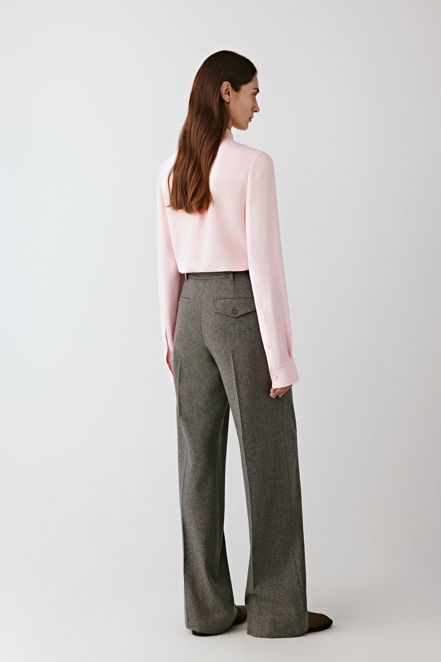 Side view capturing the gentle movement and natural fluidity of the silk crêpe as it drapes along the arm and body.