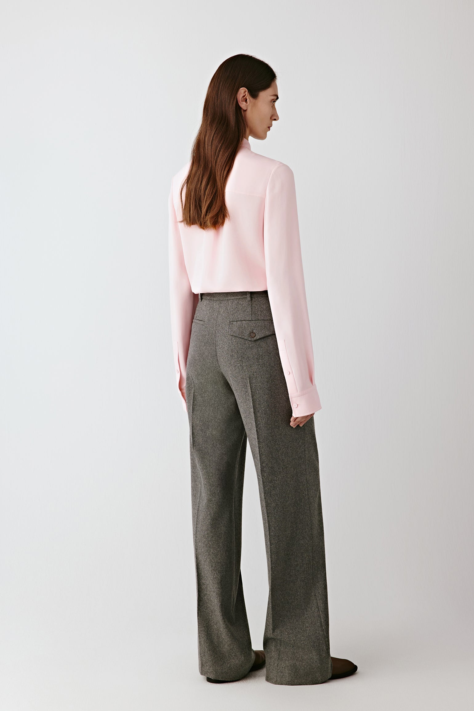 Side view capturing the gentle movement and natural fluidity of the silk crêpe as it drapes along the arm and body.