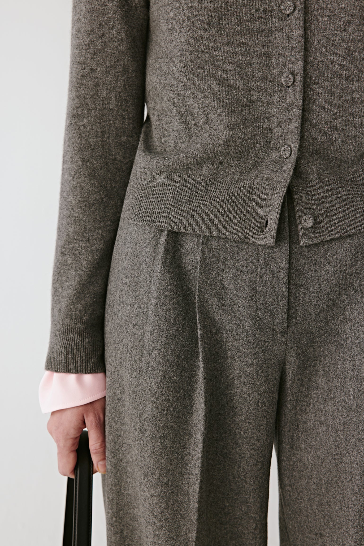 Detail close-up of the ribbed cuffs and tonal button placket.