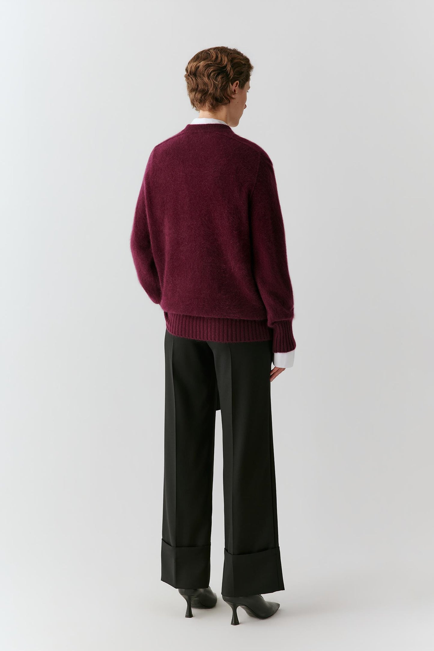 Back view showing the relaxed silhouette, raglan sleeves and clean construction of the burgundy cashmere pullover.