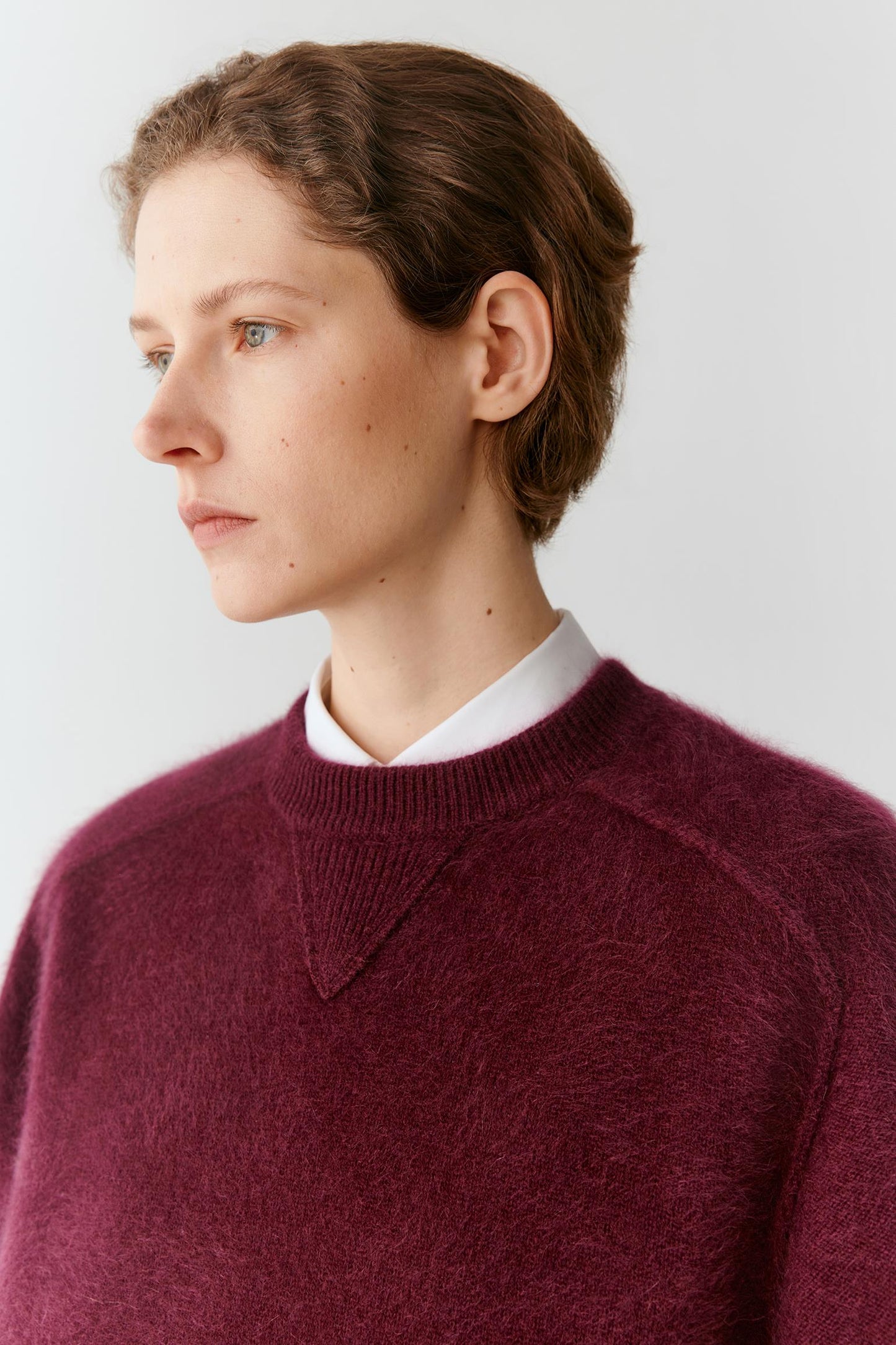 Closer front view highlighting the crew neckline, soft brushed surface and triangular stitch detail.