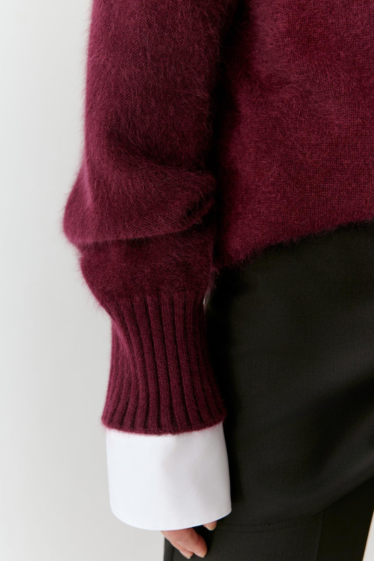Close-up of the sleeve and cuff, highlighting the ribbed finish and soft cashmere texture.