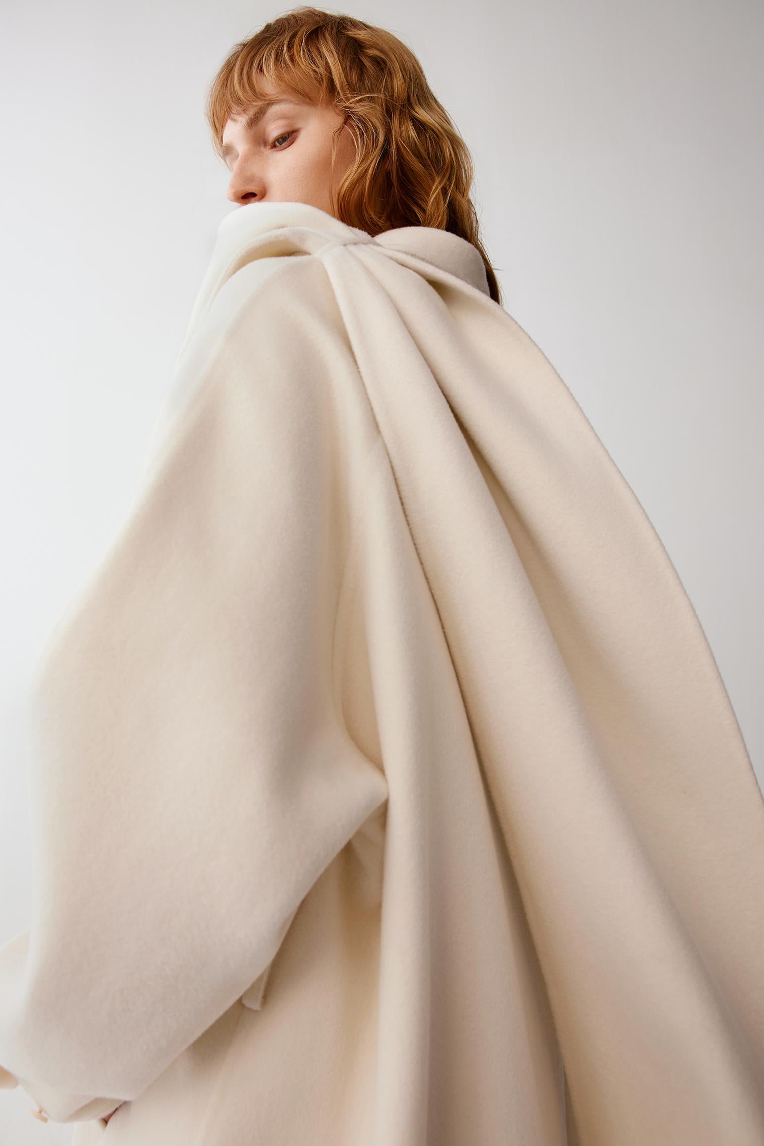 Back view highlighting the folded collar, clean shoulder construction and fluid drape of the double-face fabric.