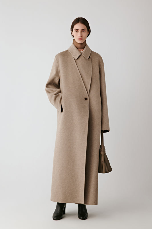 Full-length front view of the model wearing the undyed taupe double-faced cashmere coat.