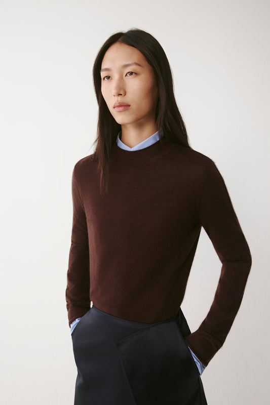 Three-quarter view of the pullover, showing the soft drape and neat fit.