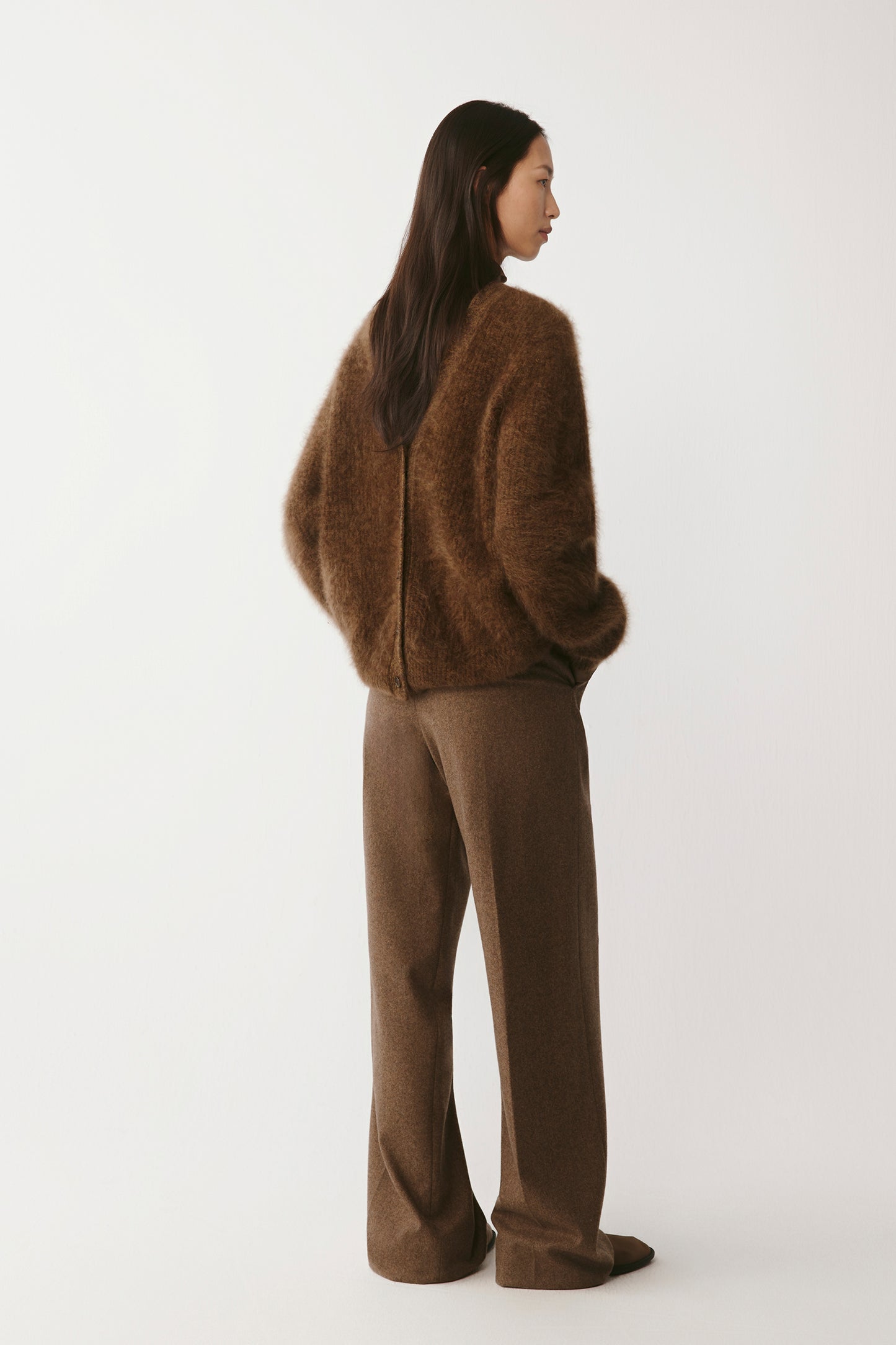Side view highlighting the garment’s clean silhouette and drape.