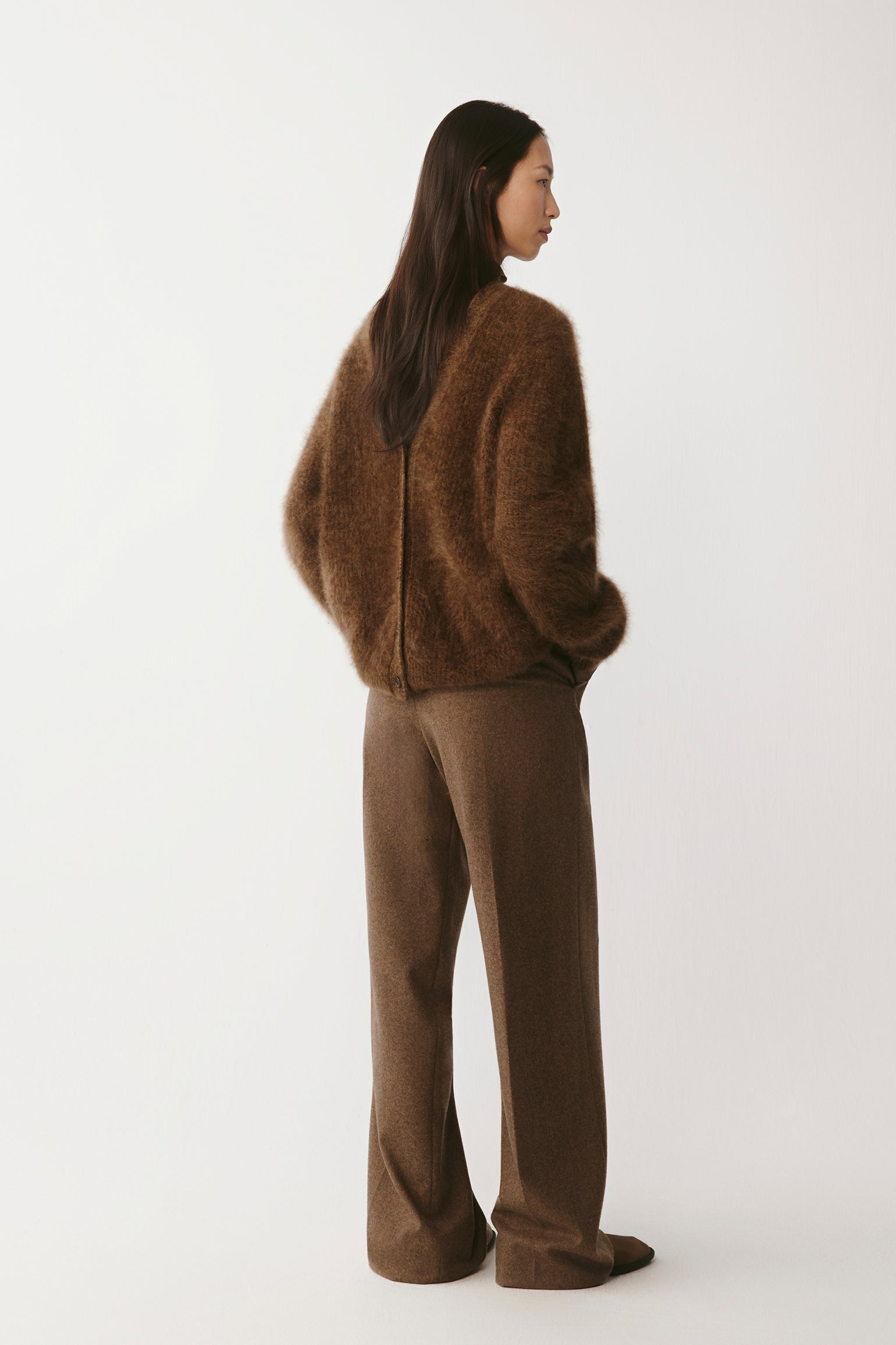 Side view highlighting the garment’s clean silhouette and drape.