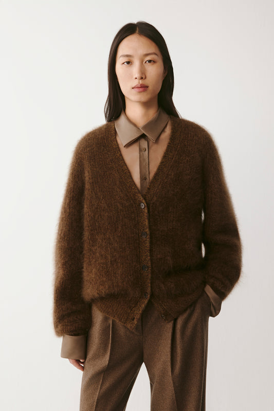 Three-quarter front view showing the cardigan’s relaxed fit and soft texture.