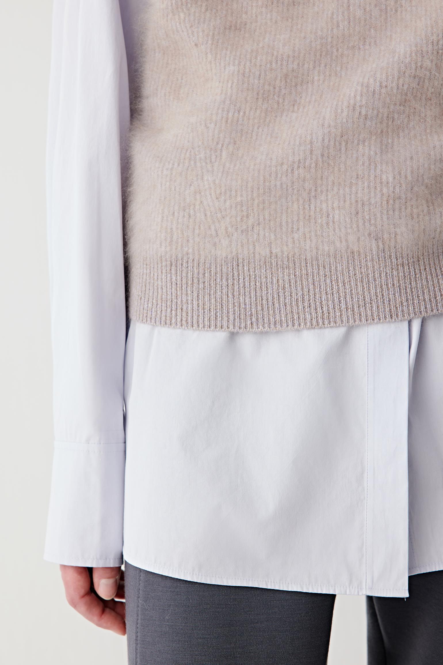 Close-up of the hem and fabric surface, showing soft fibres and clean finishing.