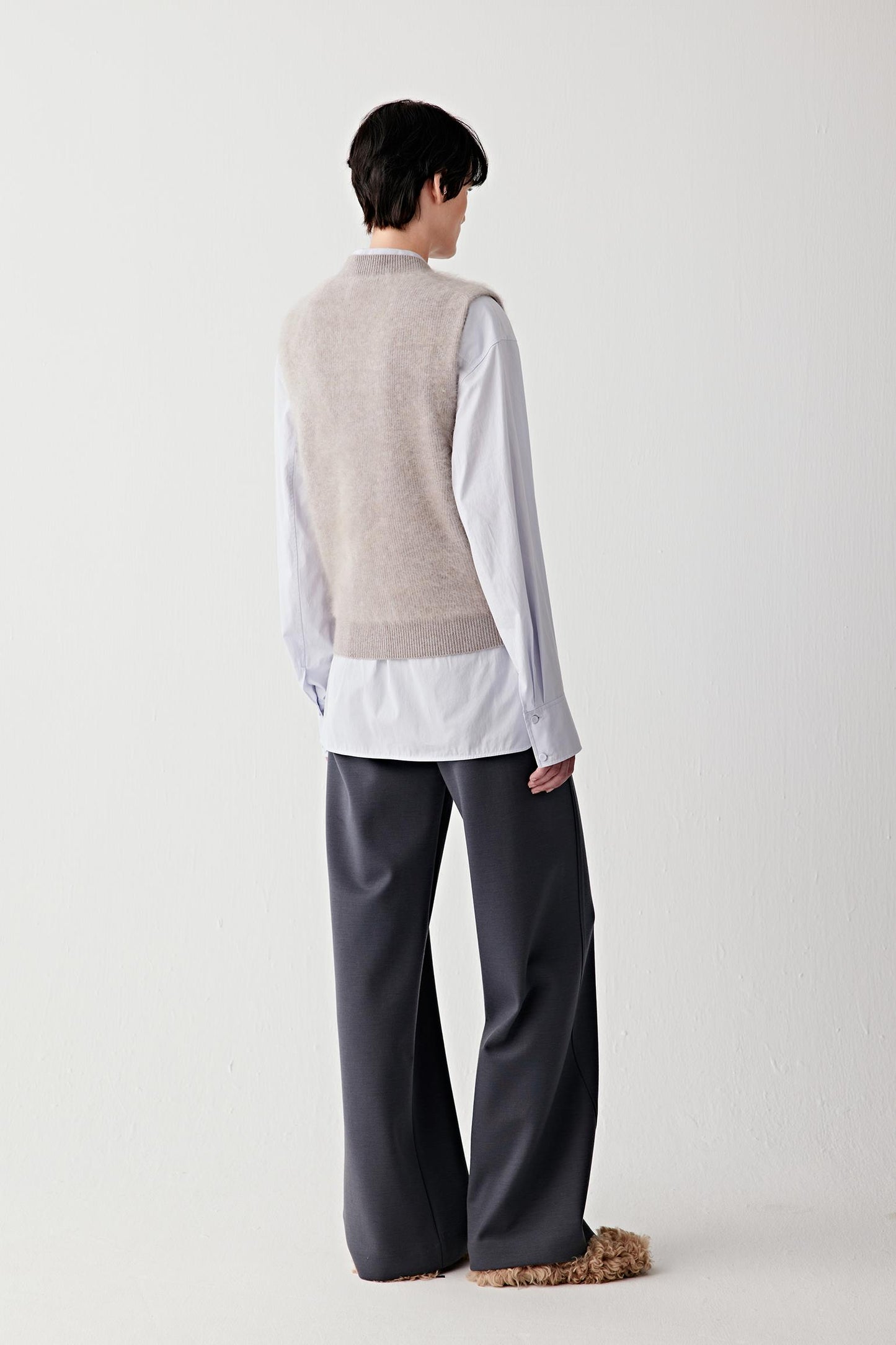 Side view of the pullover, highlighting the fluid drape and lightweight texture.