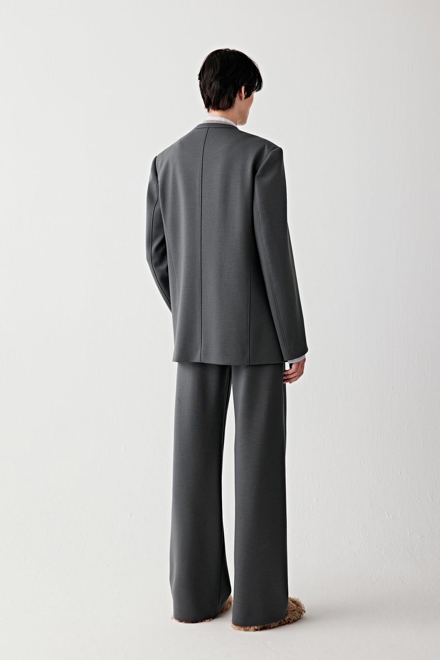 Back view of the jacket, highlighting the straight cut and balanced proportions.