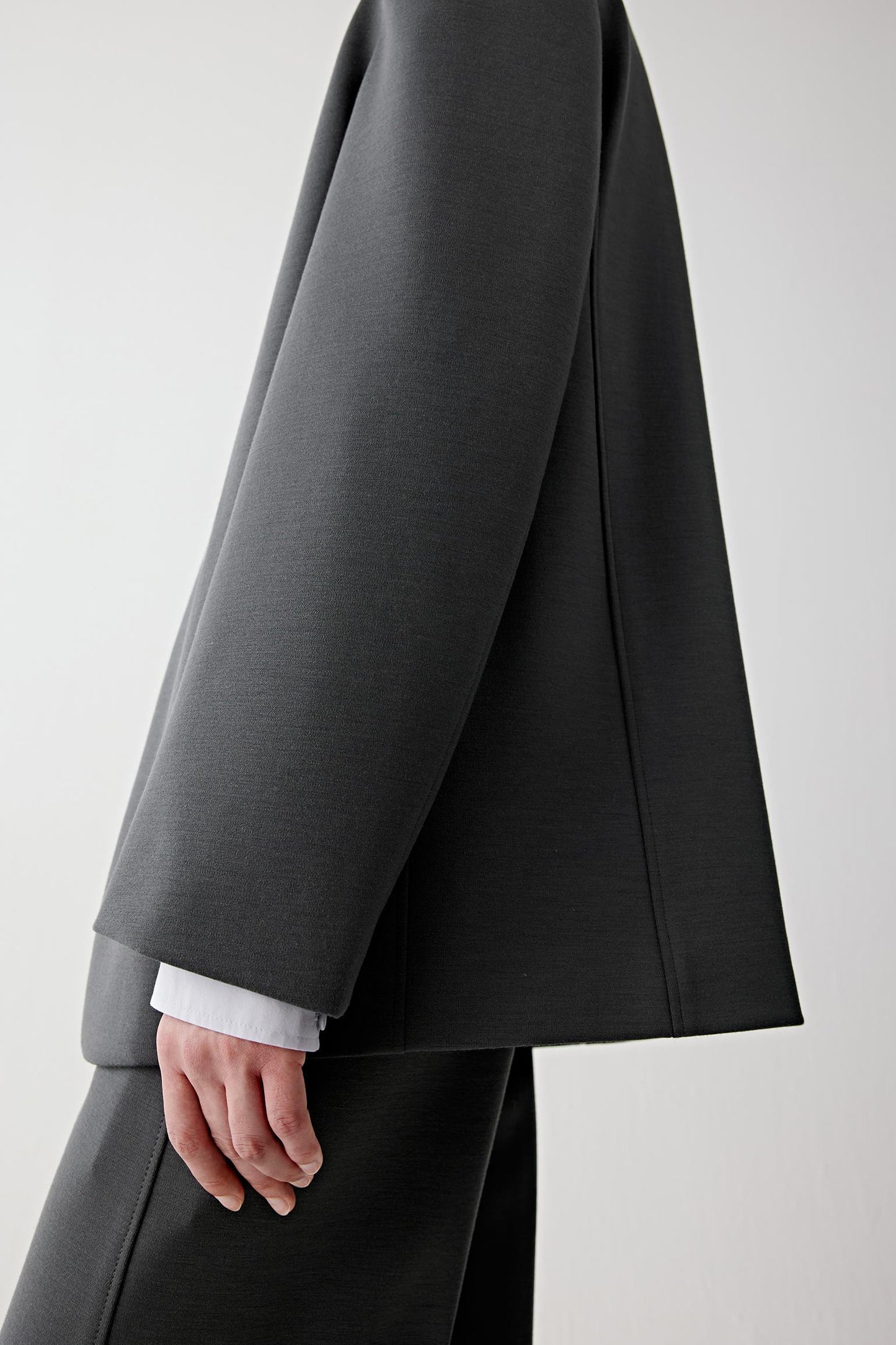 Detail of the sleeve and pocket, emphasizing refined finishing and clean construction.