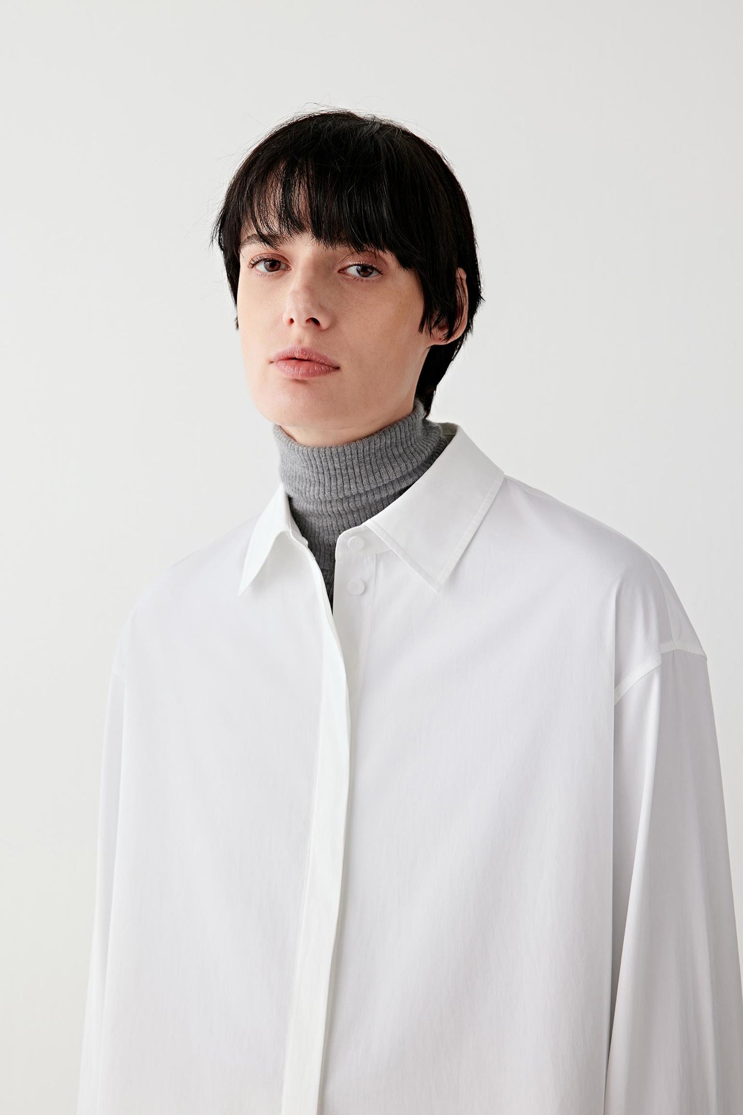 Close-up of the classic collar and top button in white cotton poplin.