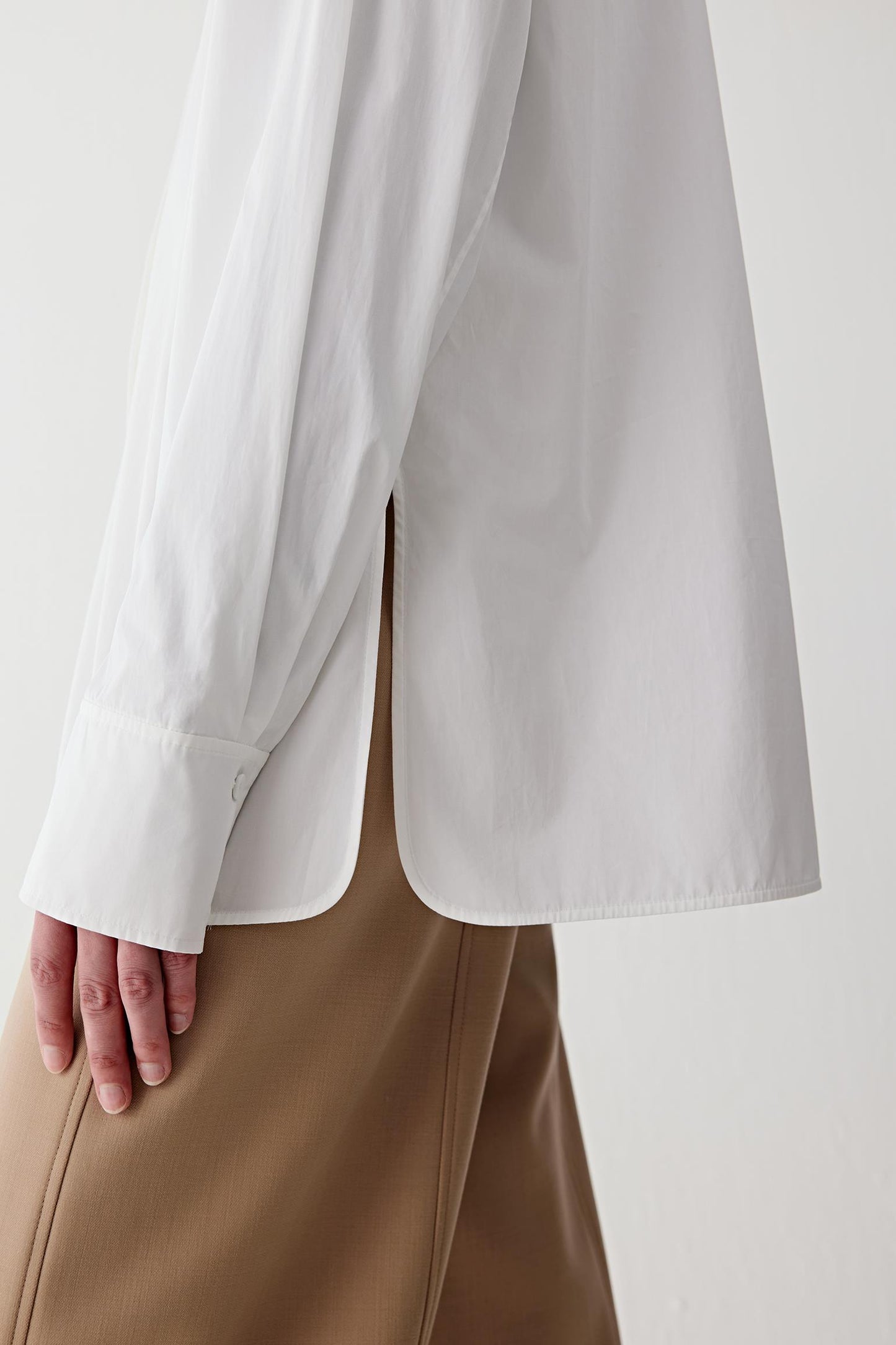 Detail close-up of the cuff and sleeve, showing precise stitching and lightweight fabric.