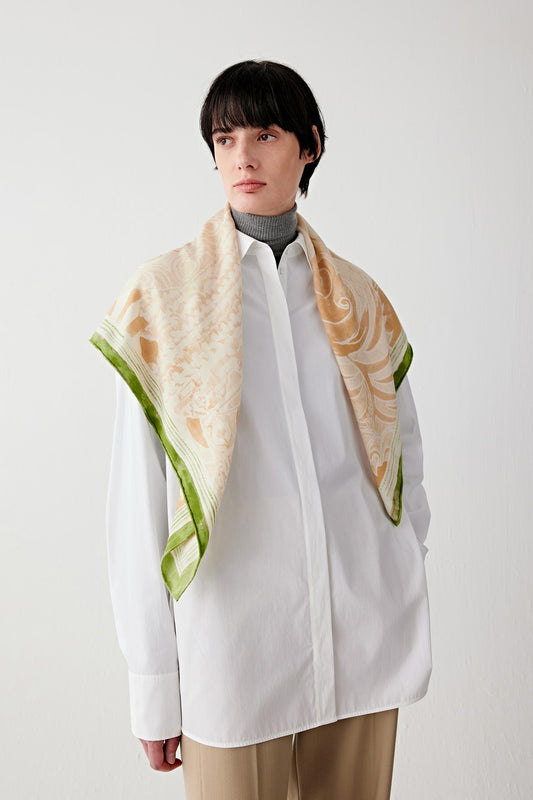 Front view of a cashmere and silk scarf with White Tiger motif worn over a light shirt, showing the motif placement at the front.