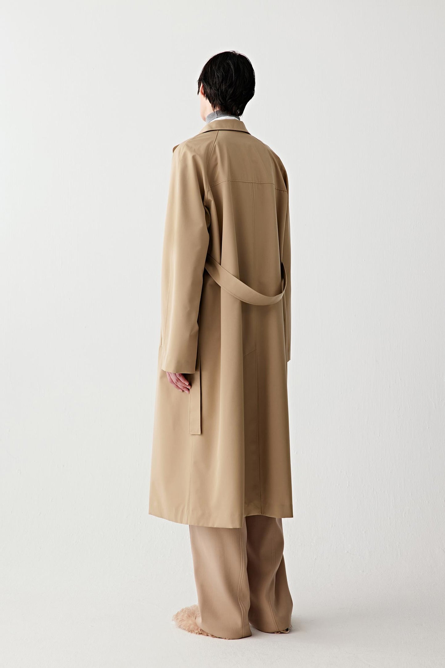 Side view of the trench coat, showing the straight fall, lightweight structure and natural movement.