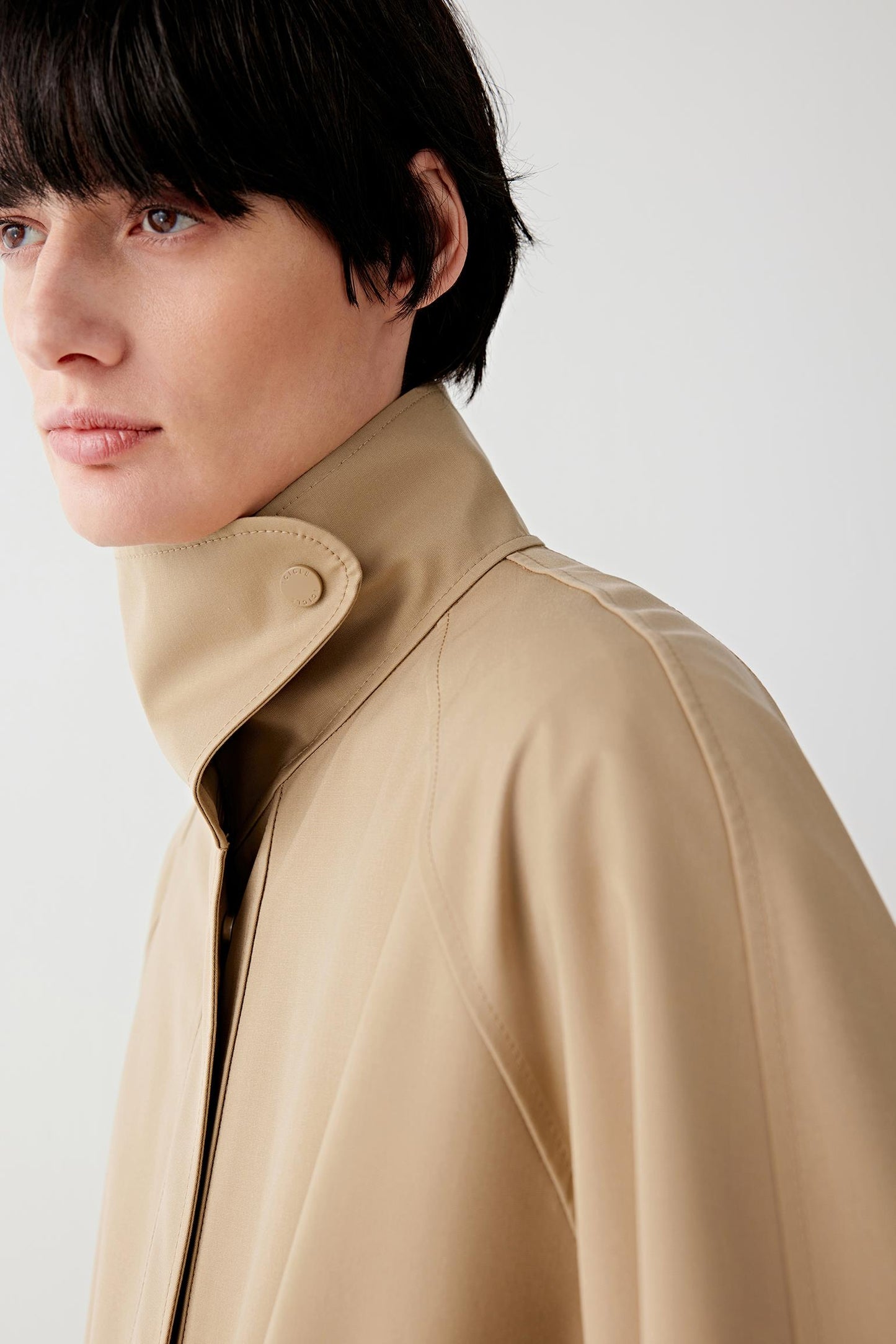 Close-up of the collar and neckline, revealing clean construction and smooth wool-silk texture.