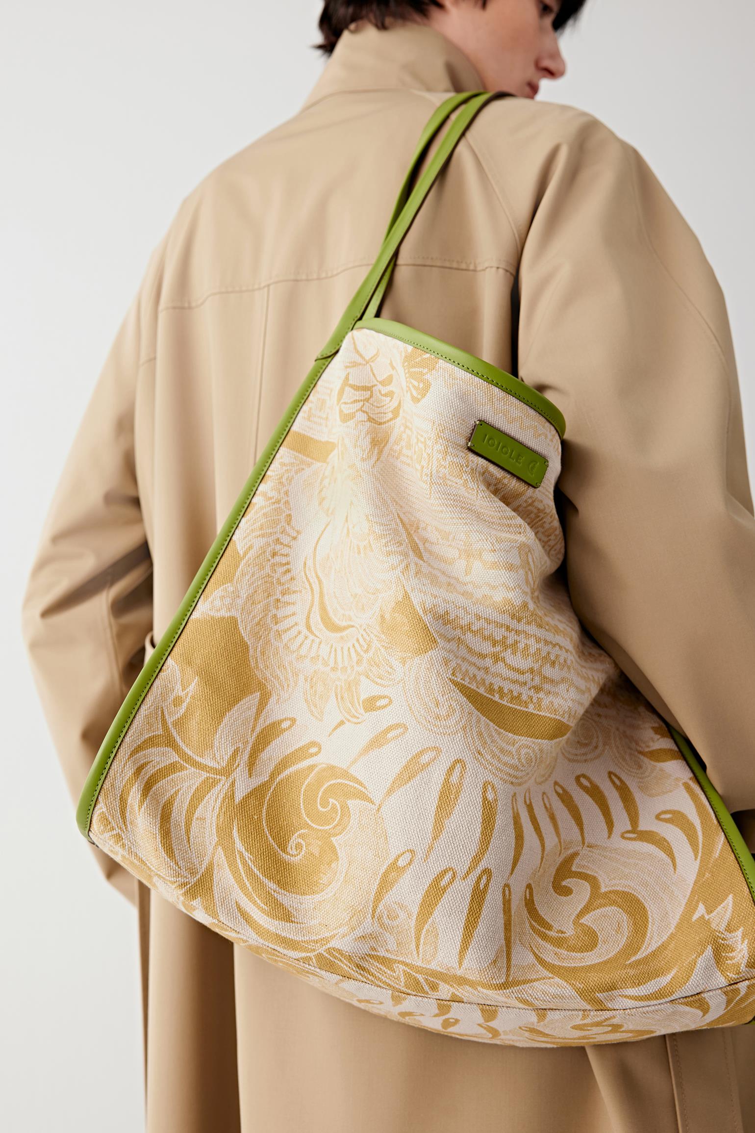 Close-up of the linen and cotton tote bag, highlighting the yellow graphic pattern, fabric texture and strap attachment details.