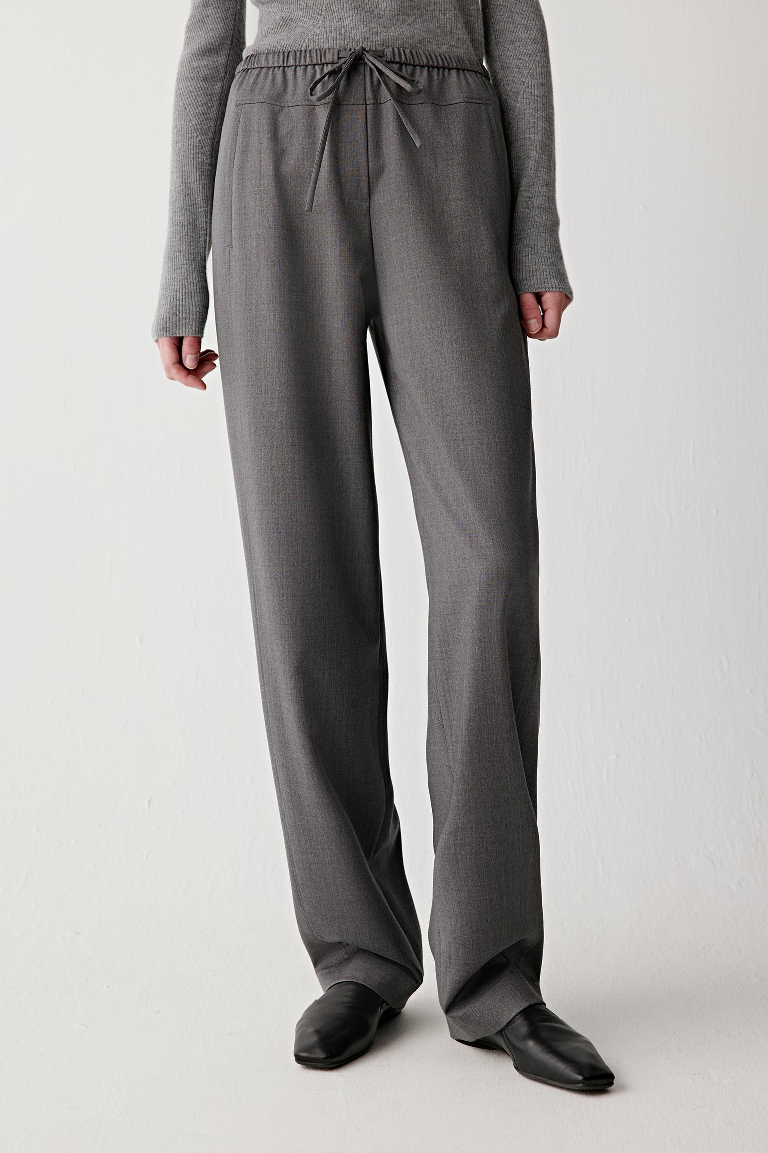 Three-quarter front view showing the fluid drape and relaxed leg shape.