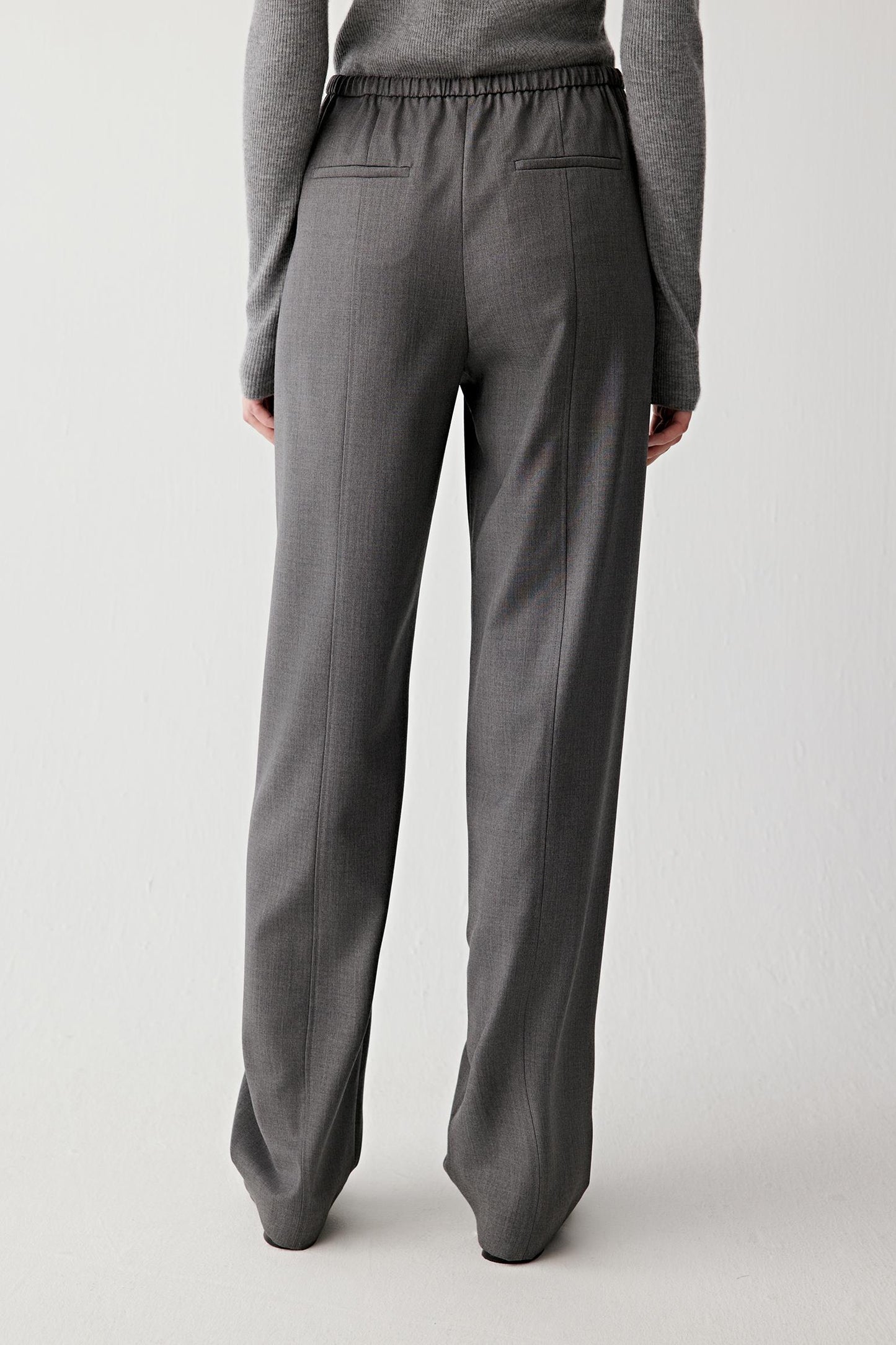 Back view of the trousers, highlighting the elasticated waistband.

