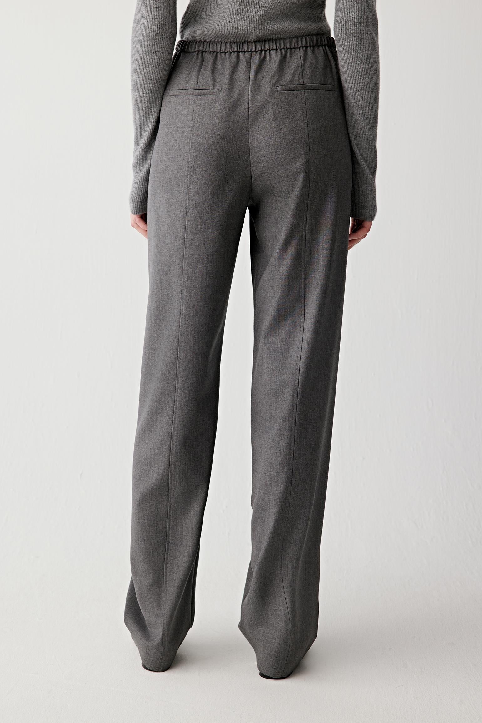 Back view of the trousers, highlighting the elasticated waistband.


