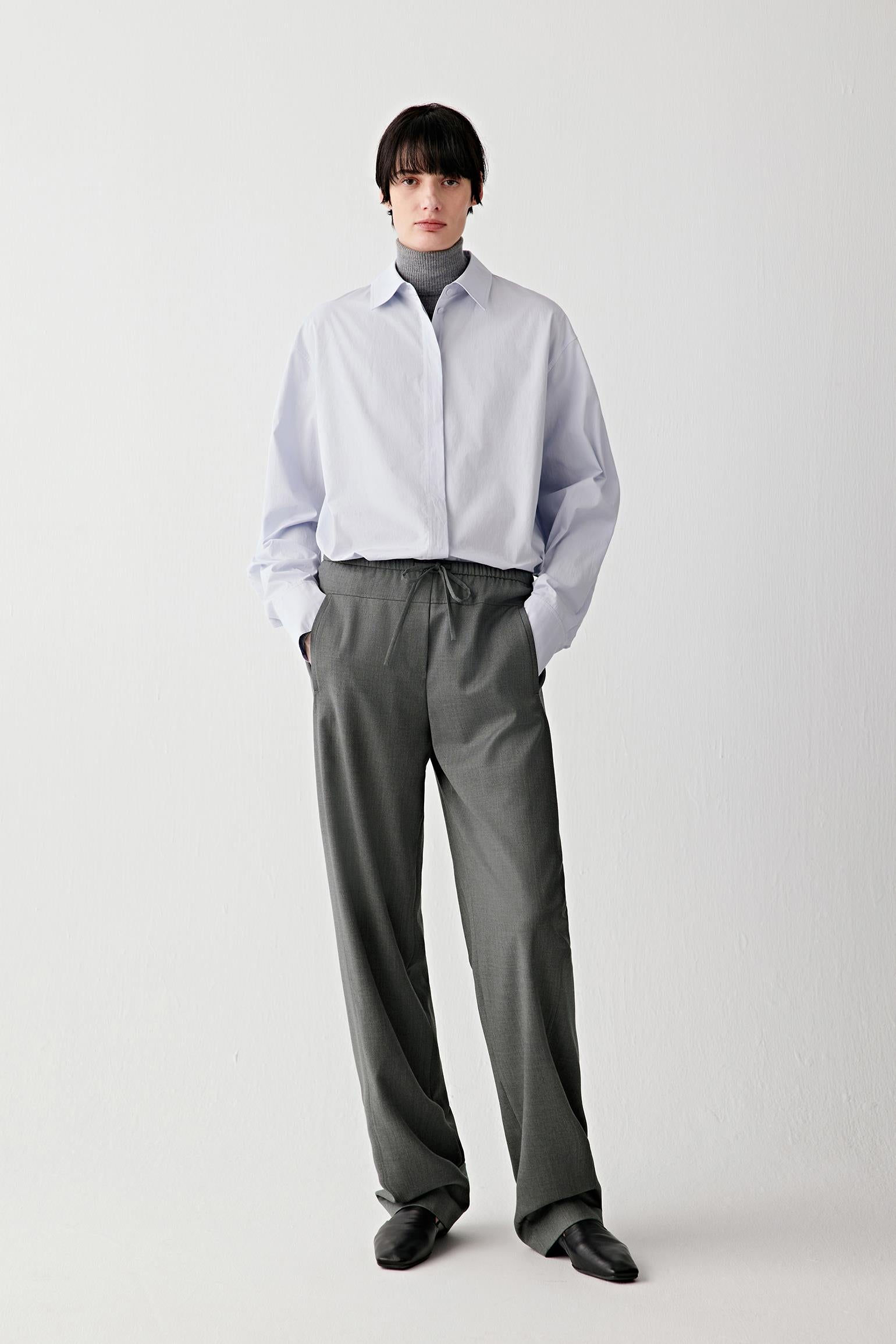 Full-length front view of straight-leg trousers in light wool twill in a subtle grey mélange.
