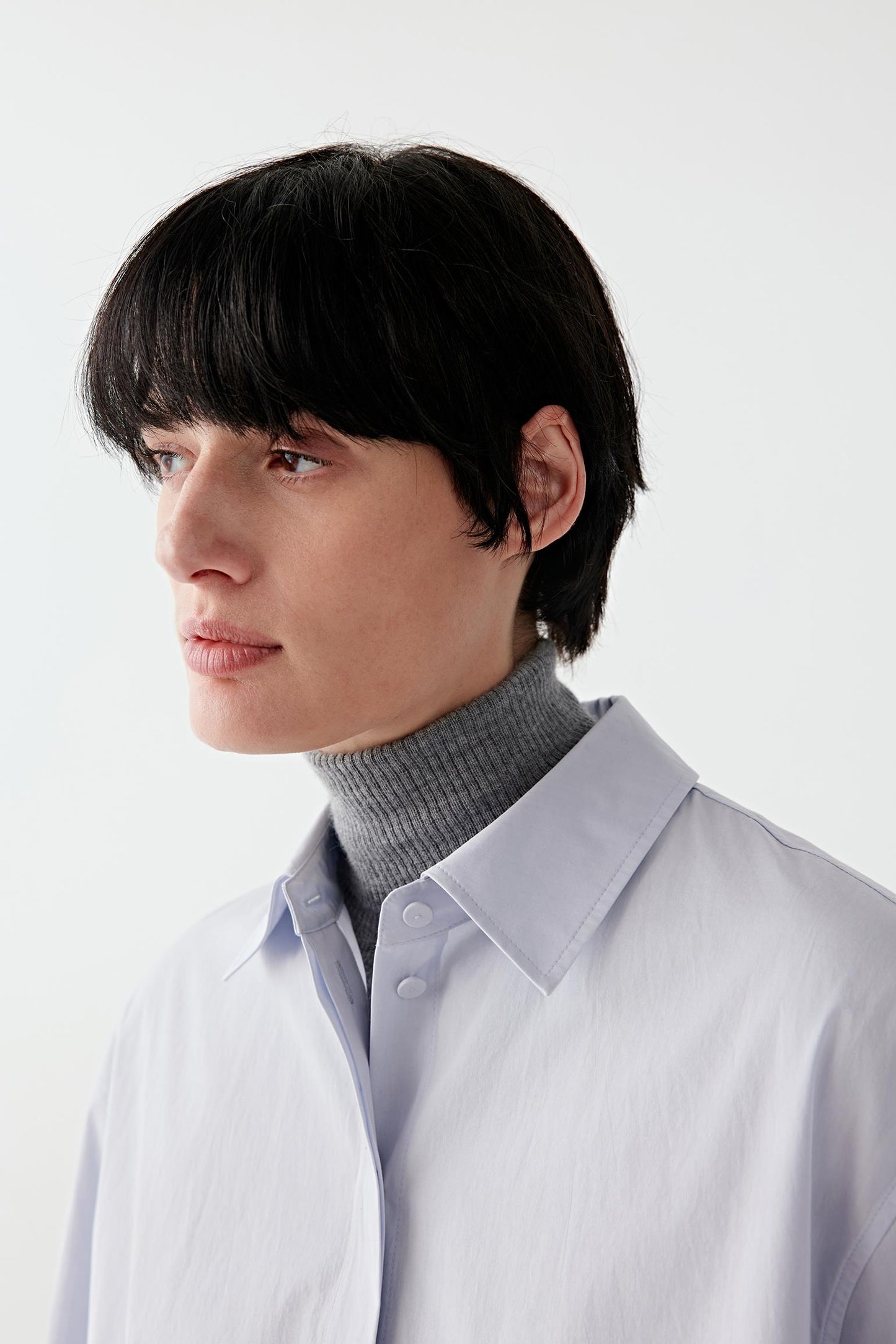 Close-up of the collar and neckline, revealing the smooth poplin texture.