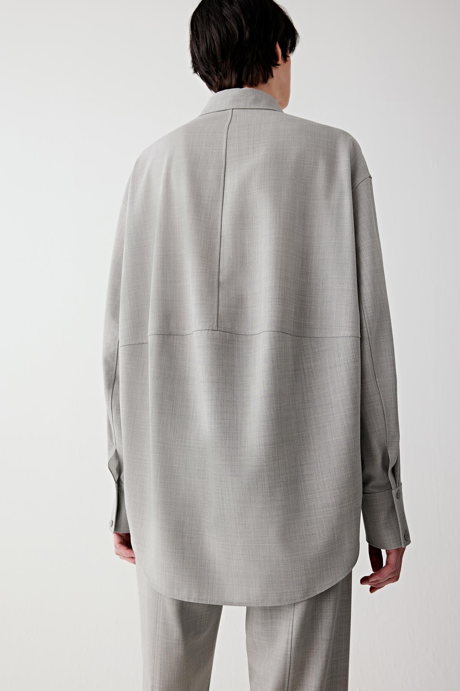 Back view of the light grey twist wool shirt highlighting the straight cut and clean shoulder line.