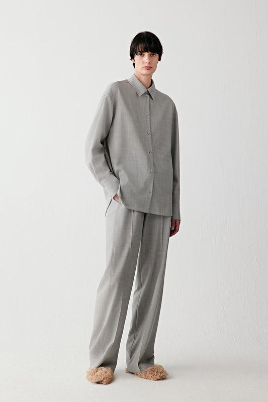 Woman wearing a light grey twist wool shirt with matching trousers, full-length front view.