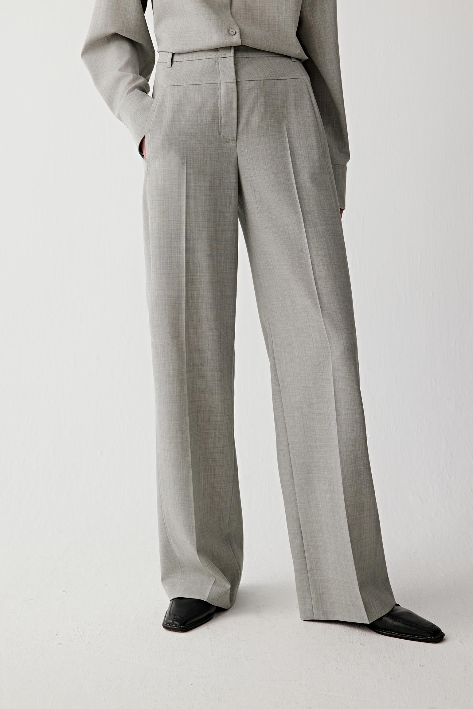 Front view of the trousers emphasizing the high waist and elongated straight-leg silhouette.