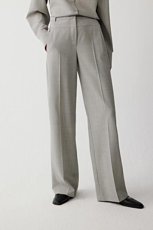 Front view of the trousers emphasizing the high waist and elongated straight-leg silhouette.
