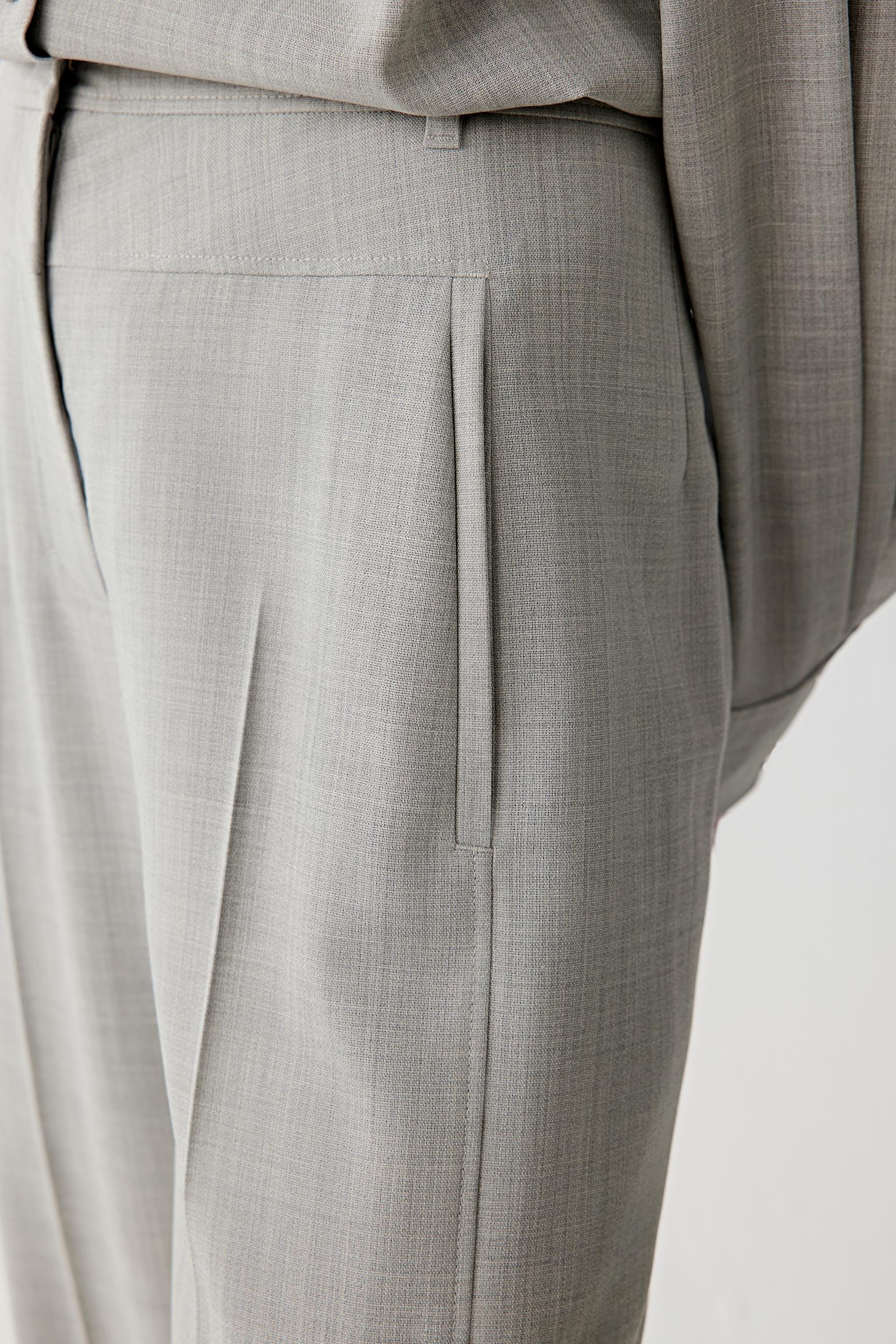 Close-up of the waistband and front pleat detailing.