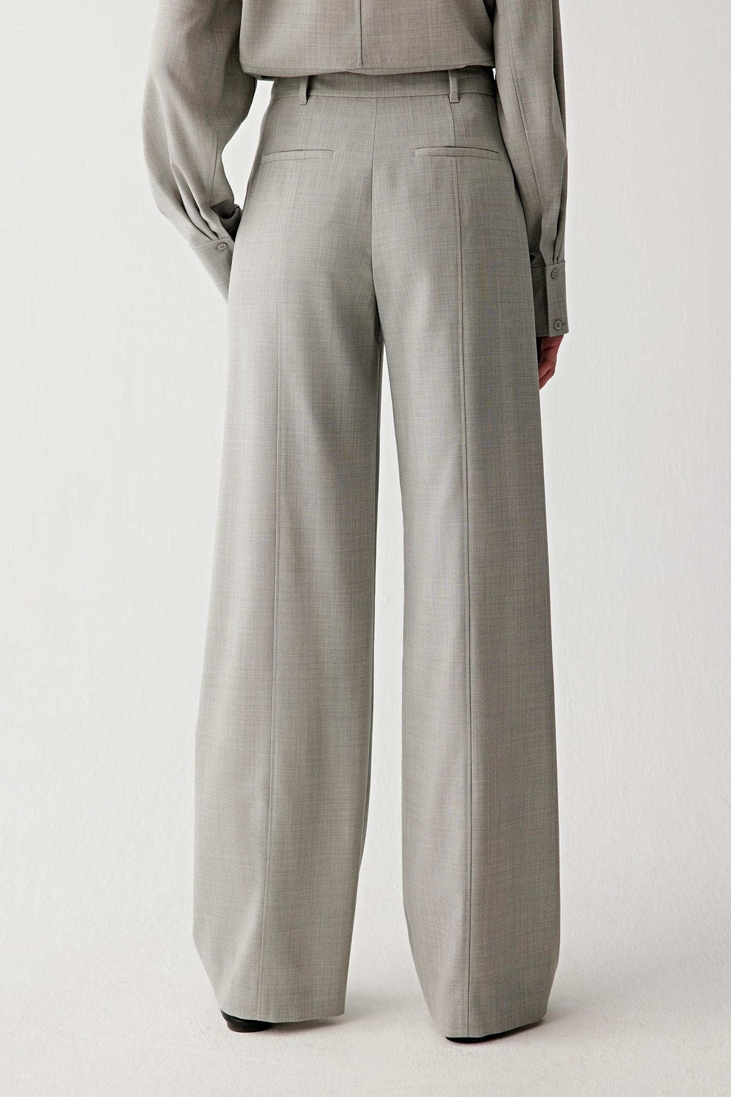 Back view showing the fluid drape and soft structure of the twist wool fabric.