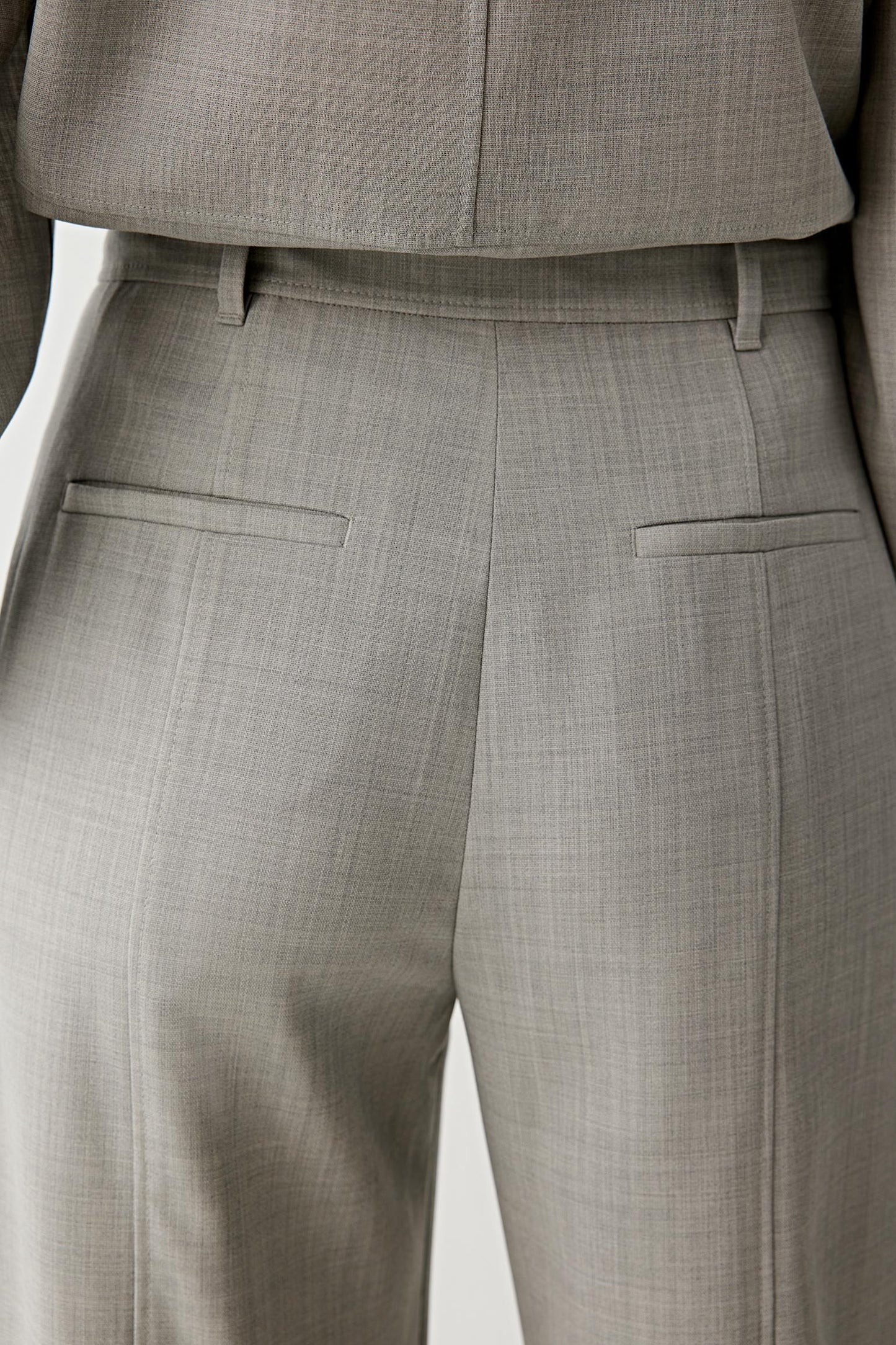 Fabric detail in light grey melange showing the fine woven texture.