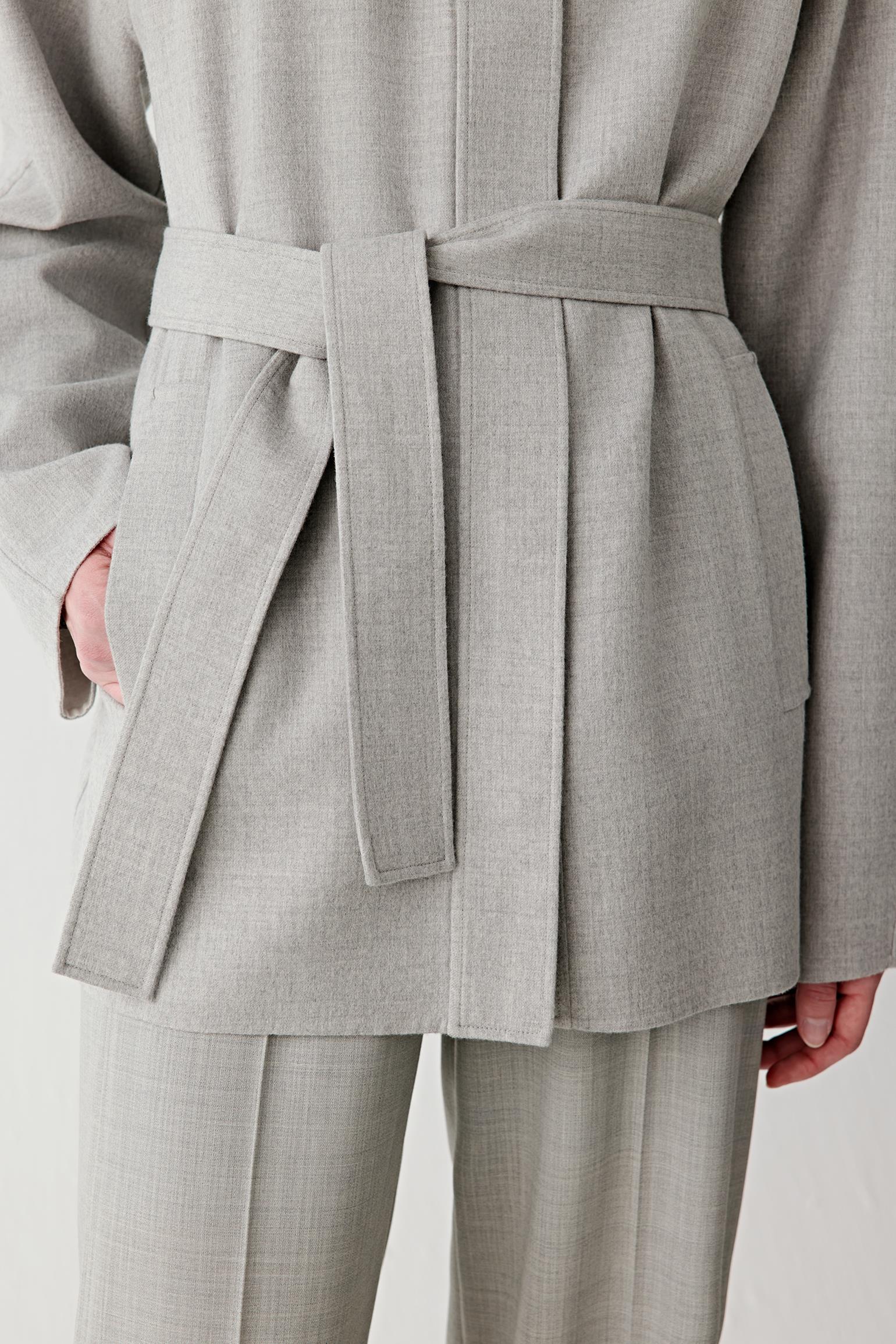 Detail of the belt and waist, highlighting the self-tie fastening, clean seams and supple yet structured fabric.
