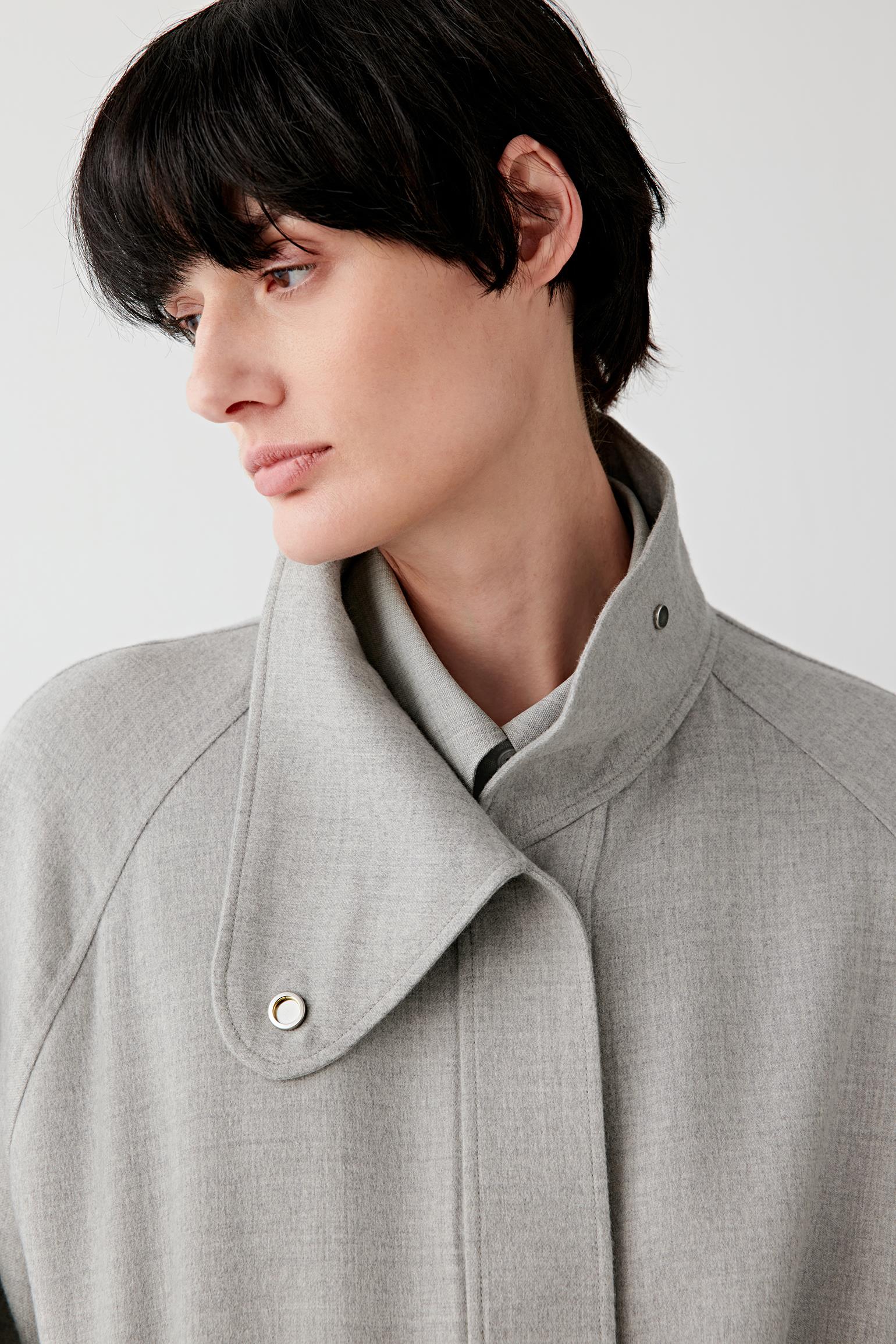 Close-up of the collar and upper front, revealing the soft double-faced wool texture, minimal construction and smooth melange finish.