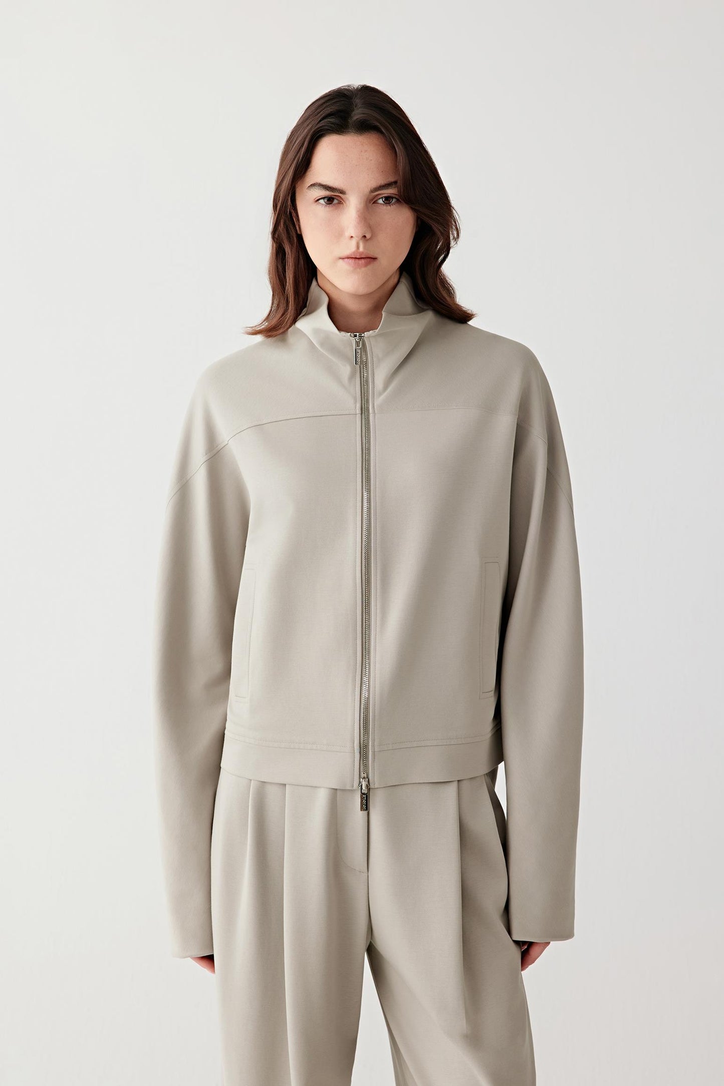 Three-quarter front view highlighting the relaxed fit and fluid drape of the cotton stretch jersey jacket.