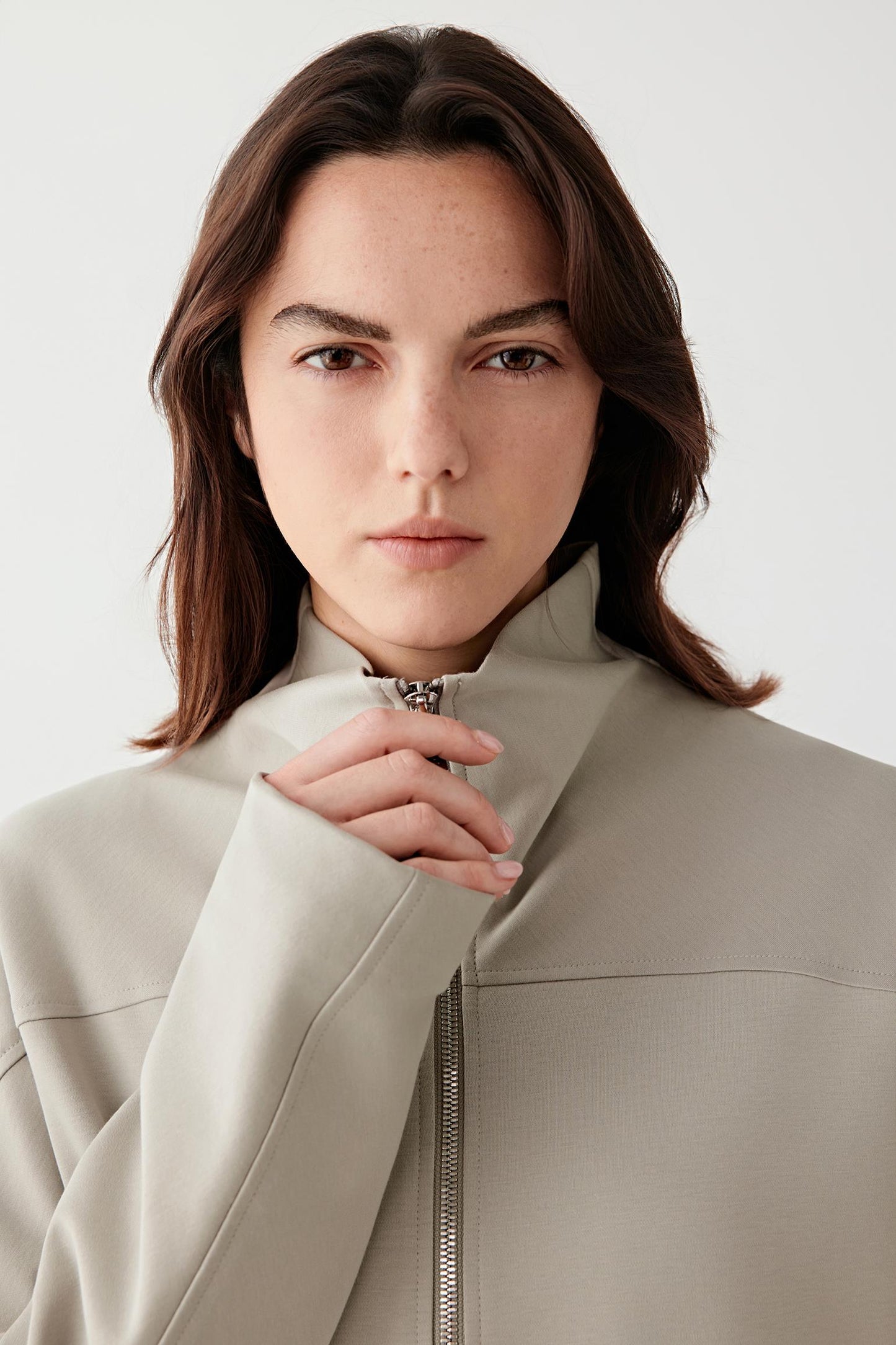 Close-up of the collar and upper front, revealing the smooth jersey texture and minimal finishing.