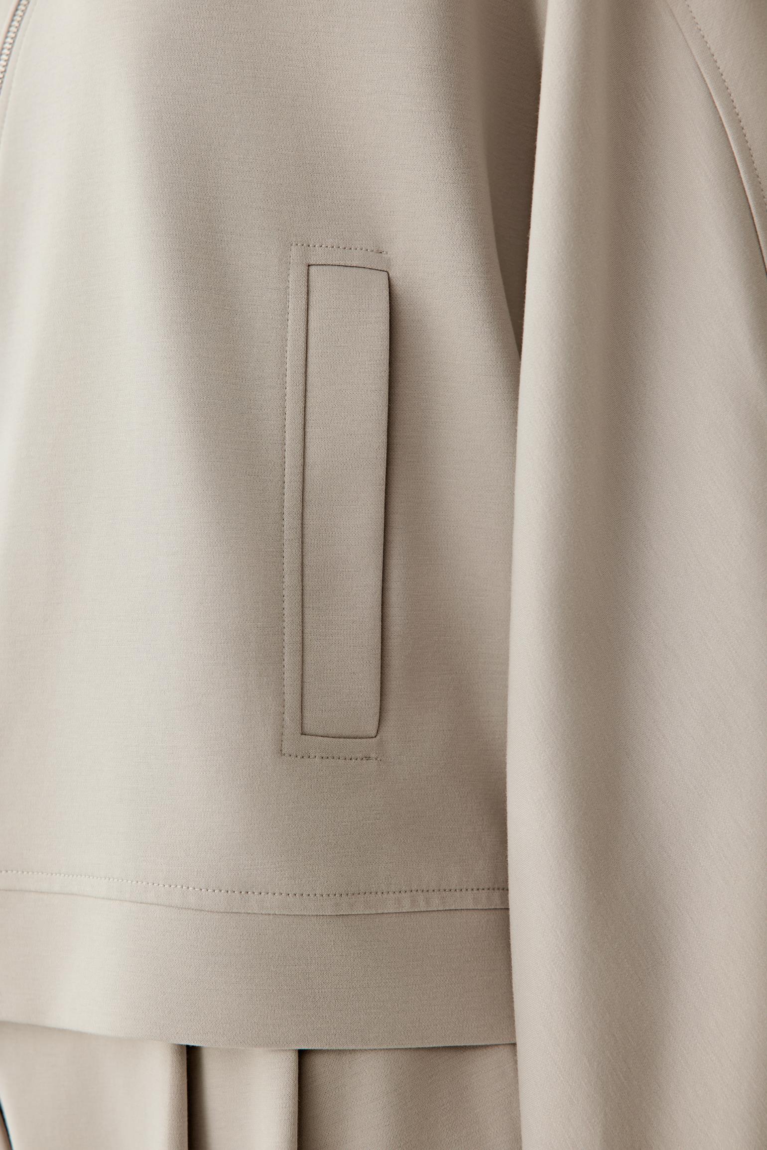 Detail close-up of the sleeve and hem, emphasizing the fabric’s softness and flexibility.