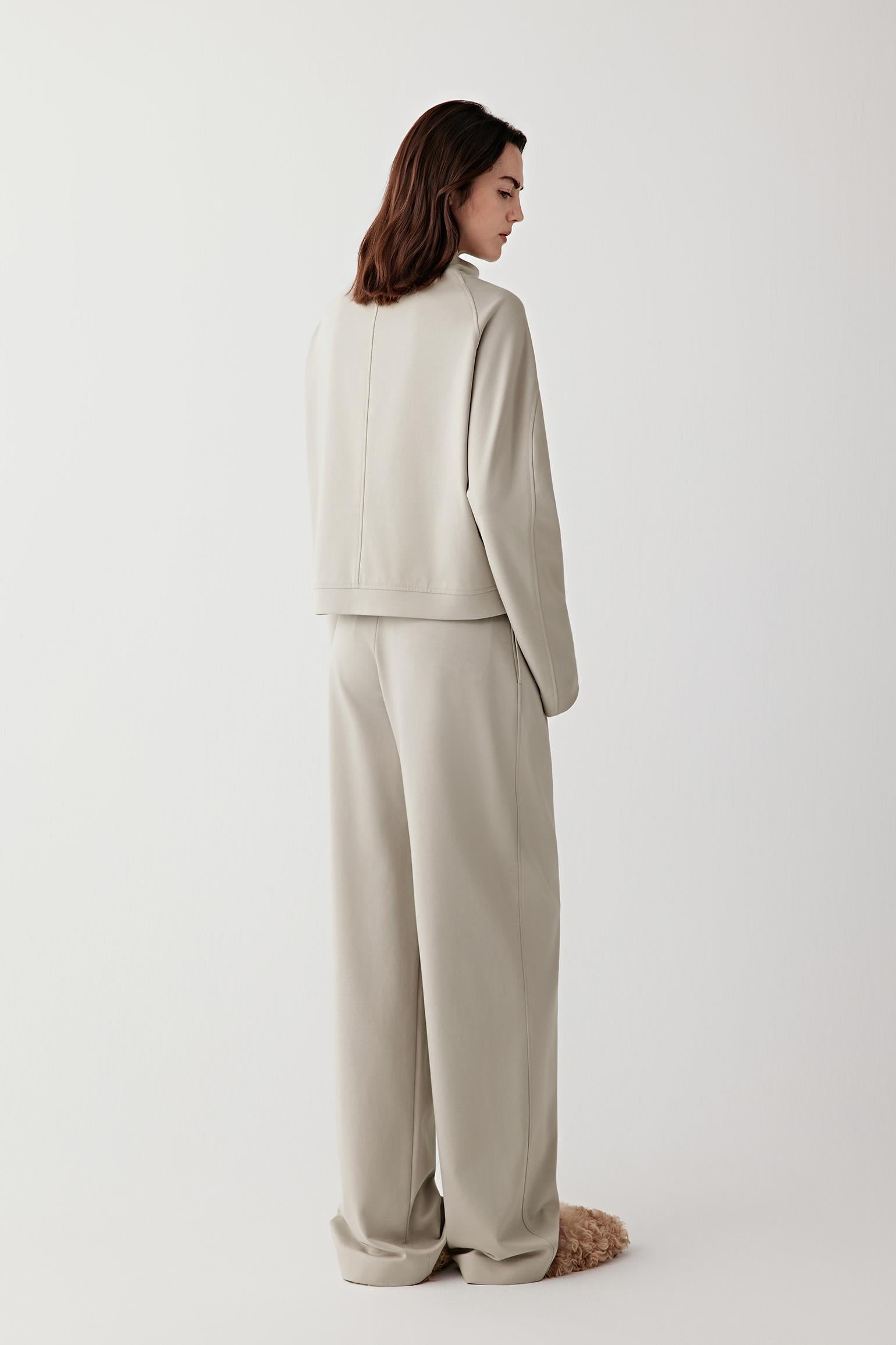 Back view of the short jacket, showing clean lines and a softly structured silhouette.
