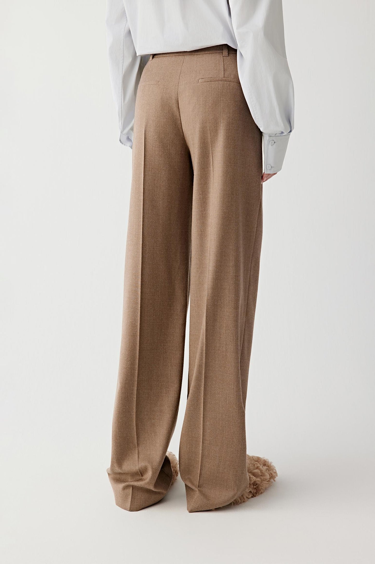 Back view of the wool flannel trousers, showing clean lines and minimal detailing.
