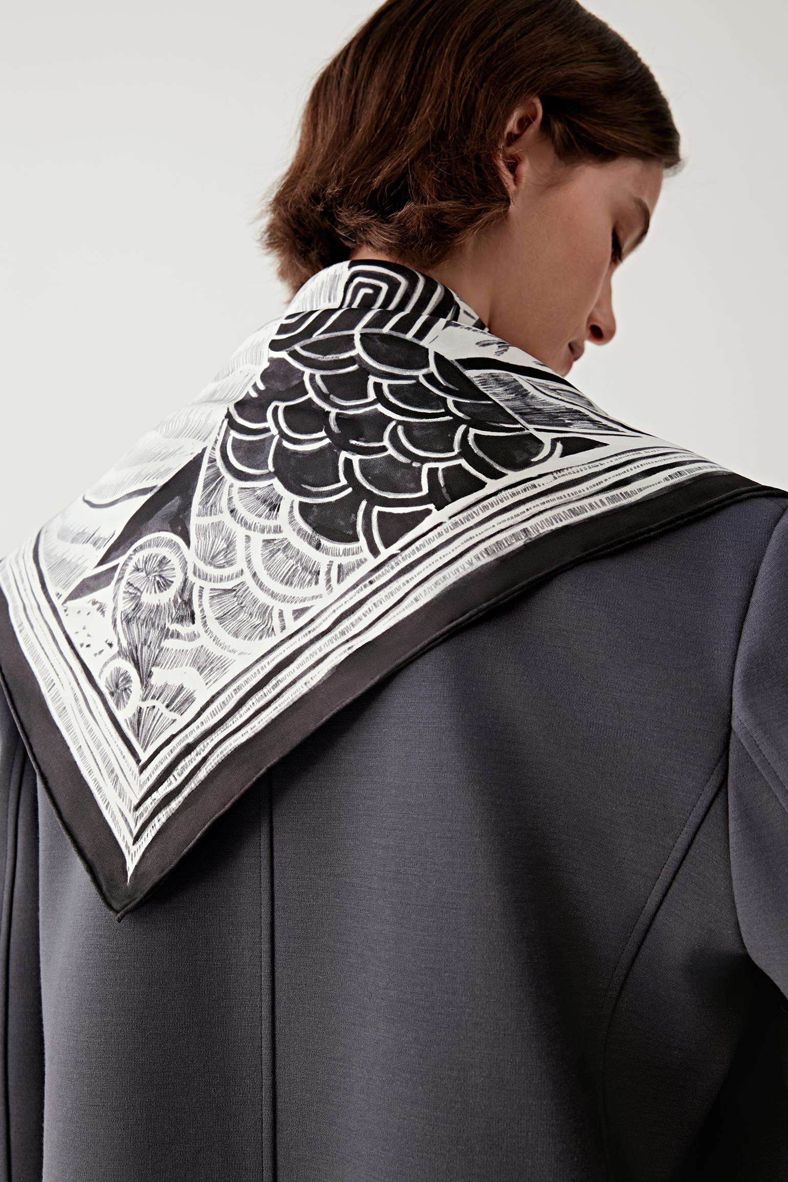 Back view of the scarf showing the large-scale black and white motif across the shoulders.