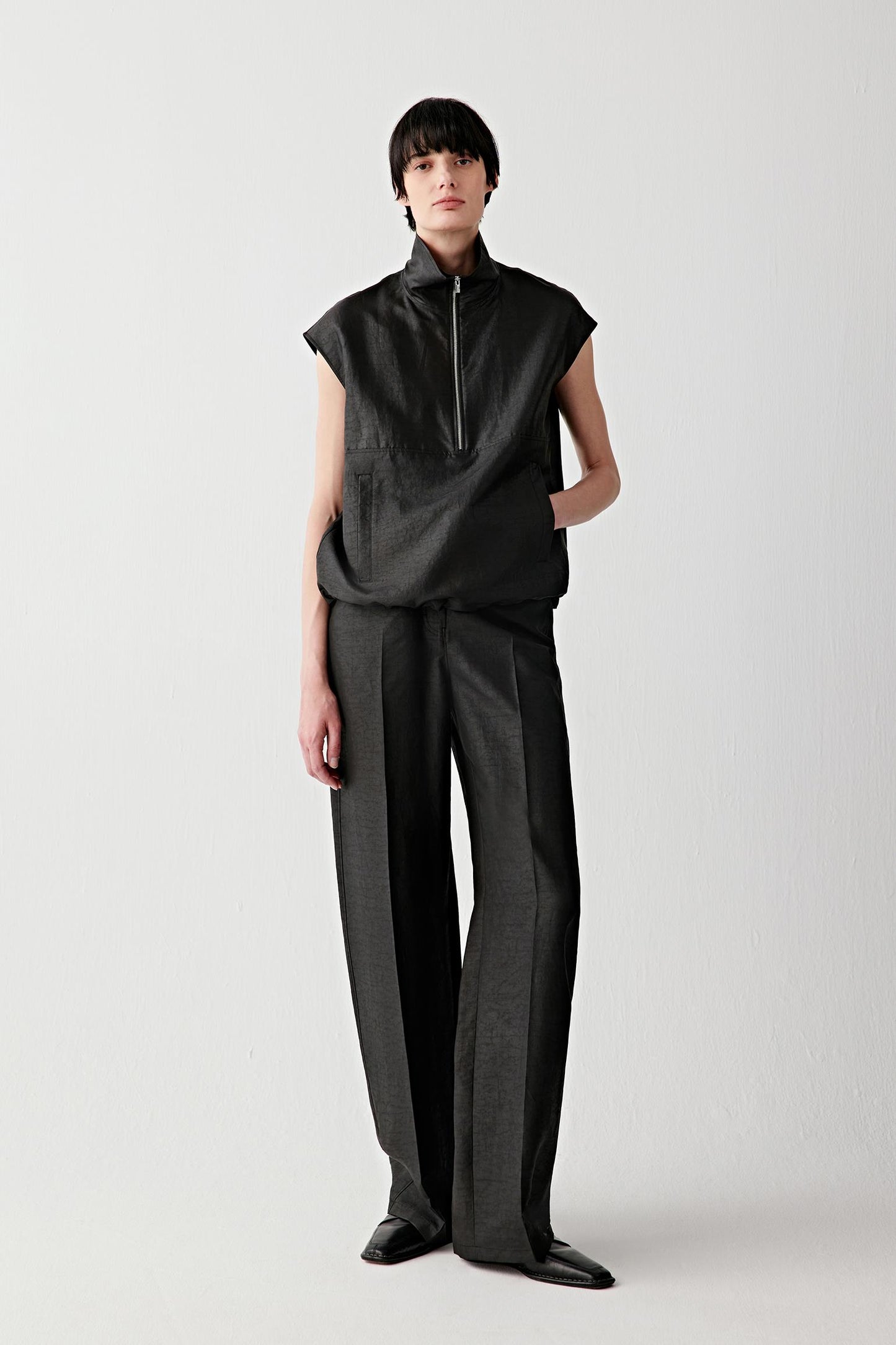 Full-length front view styled with matching trousers, emphasizing clean lines and straight cut