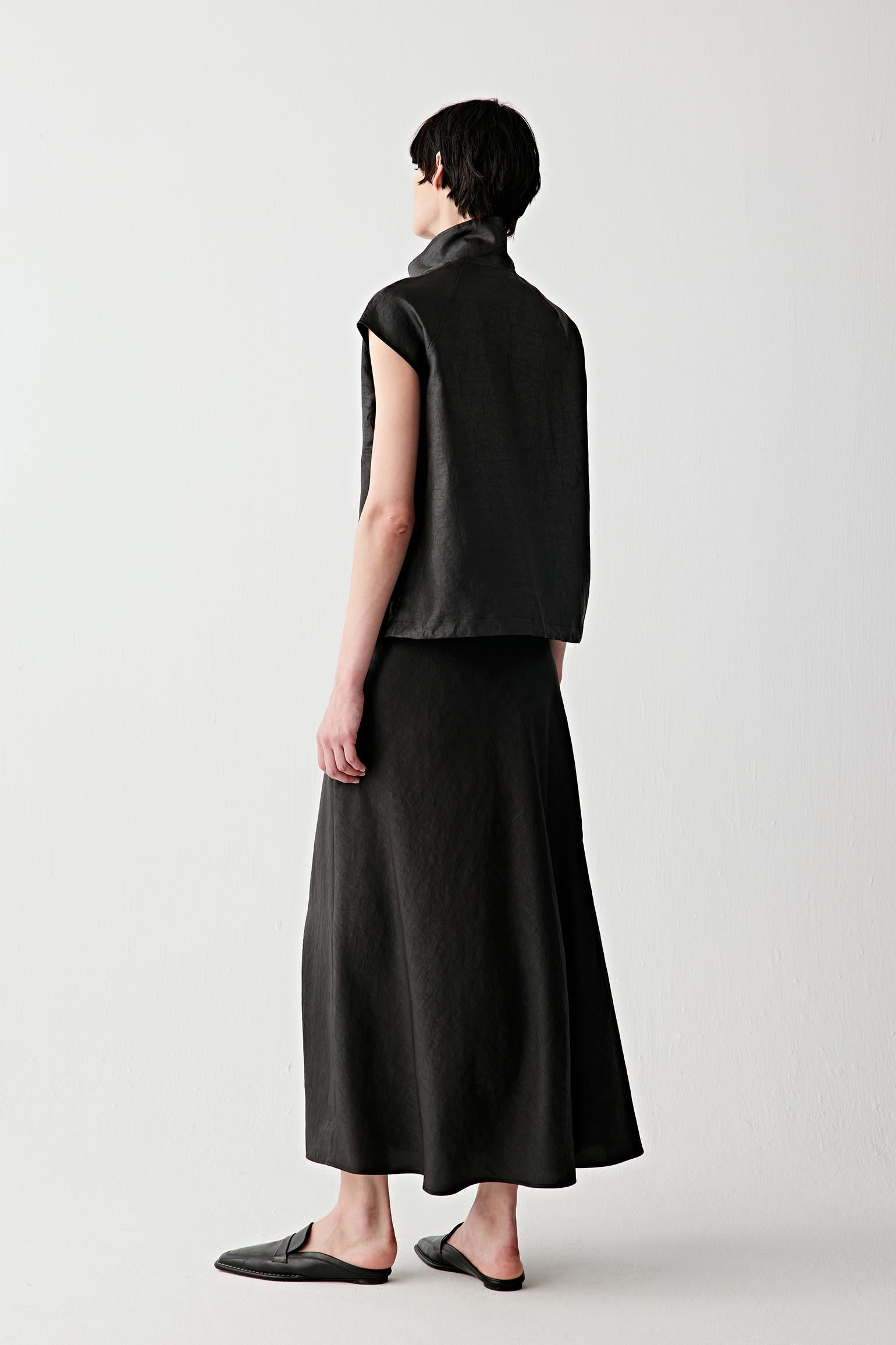 Side view showing sleeveless construction, structured shoulders and natural fall