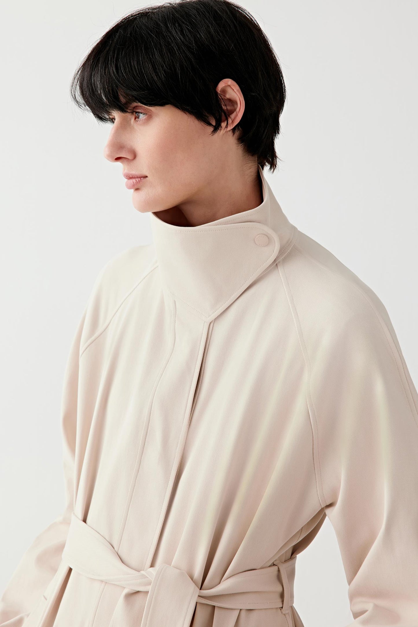 Close-up portrait showing collar, neckline and fine gabardine weave