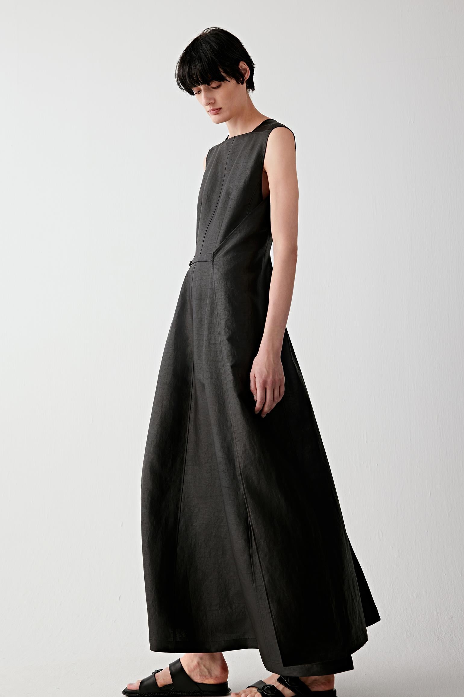 Three-quarter side view highlighting the way the dress moves with the body and subtle structure through the waist